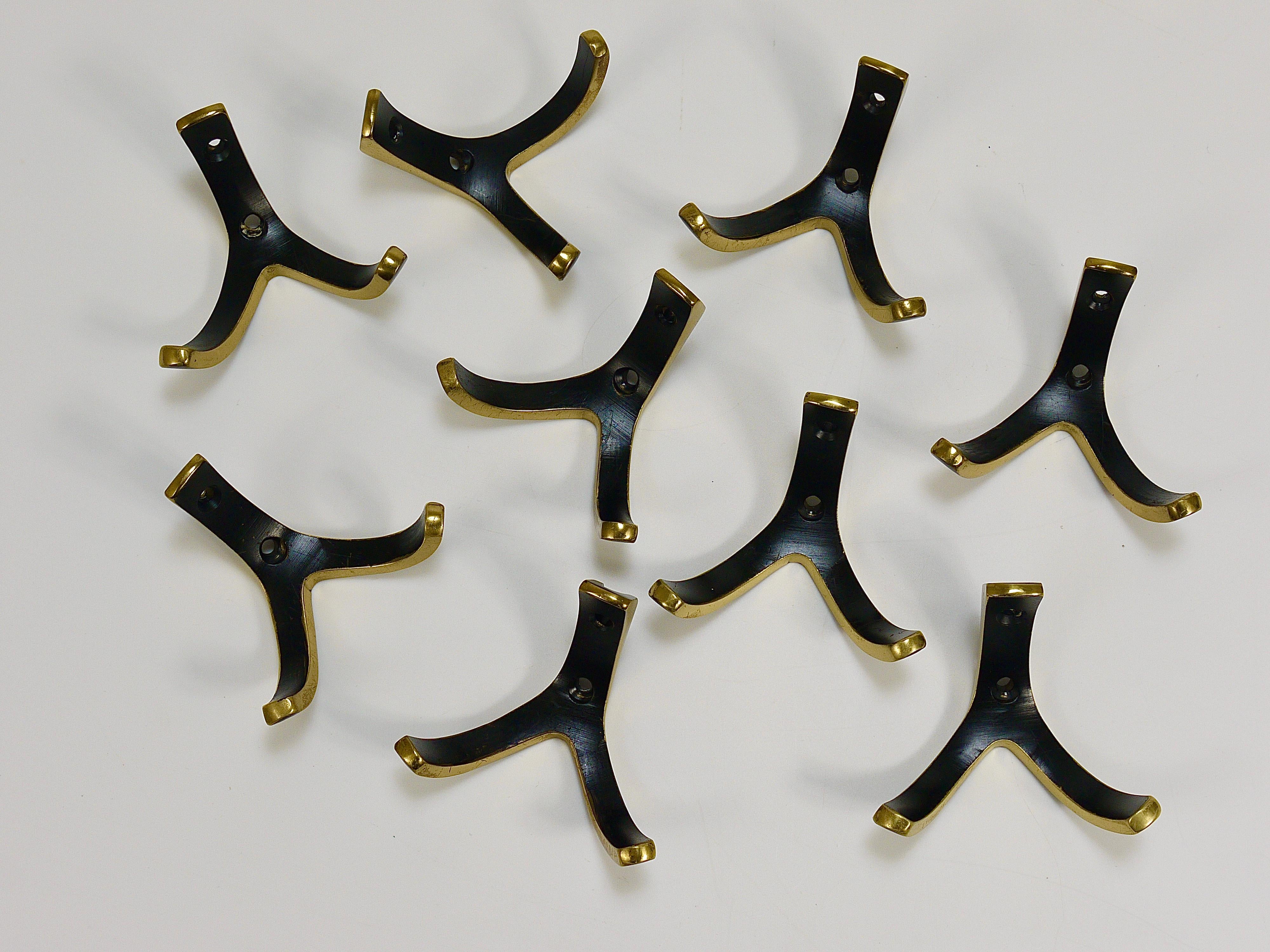 Up to 8 beautiful modernist wall hooks from the 1950s, made of solid black-finished and partly polished brass. Executed by Hertha Baller Vienna in  Austria. To be used as coat hooks, but also for towels in the bathroom or in the kitchen. In very