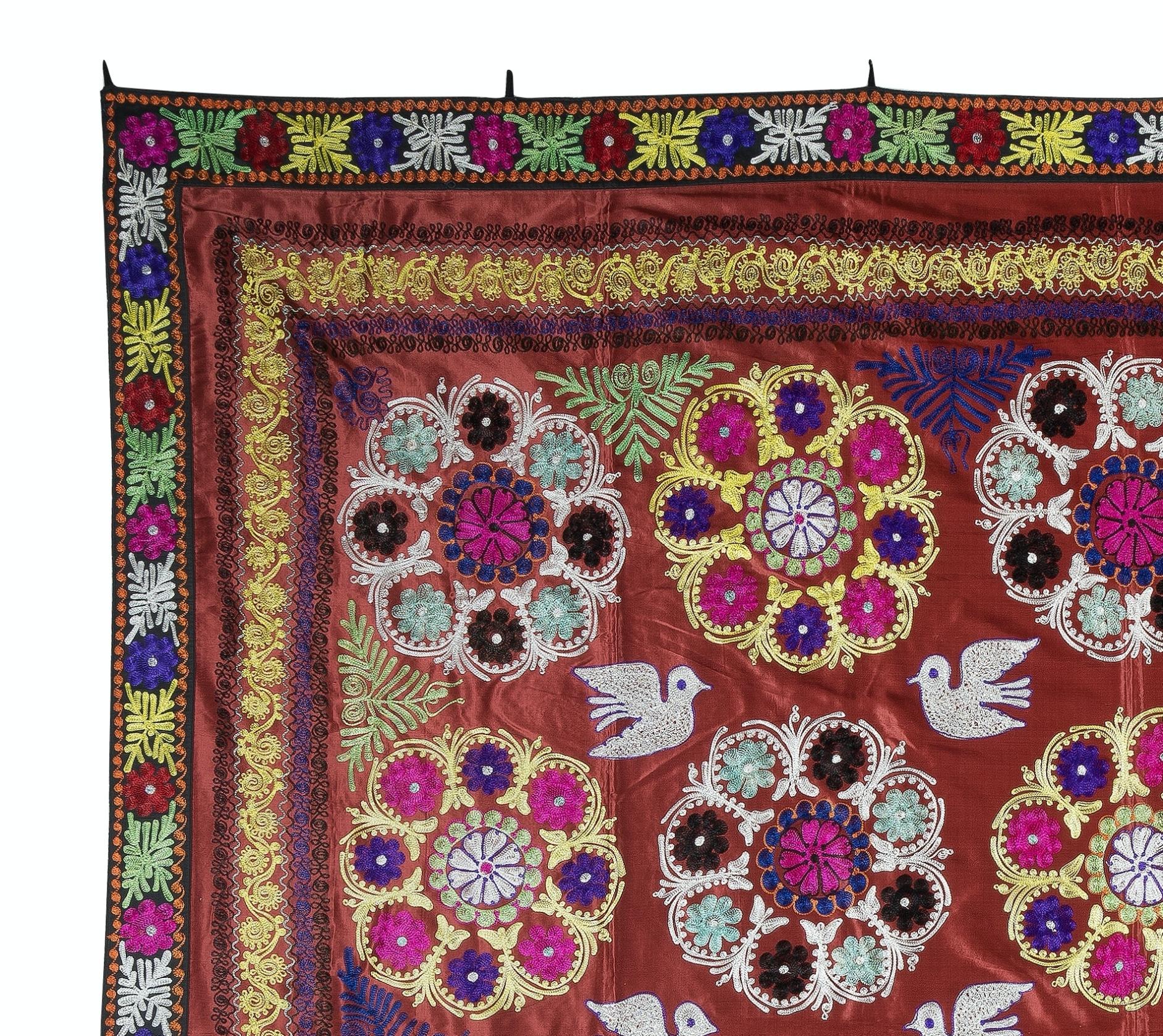 Introducing our exquisite new suzani hand embroidered wall hanging, a captivating piece that combines ancient craftsmanship with modern artistry. This embroidered cloth is not just a suzani throw, but a remarkable suzani wall hanging that will