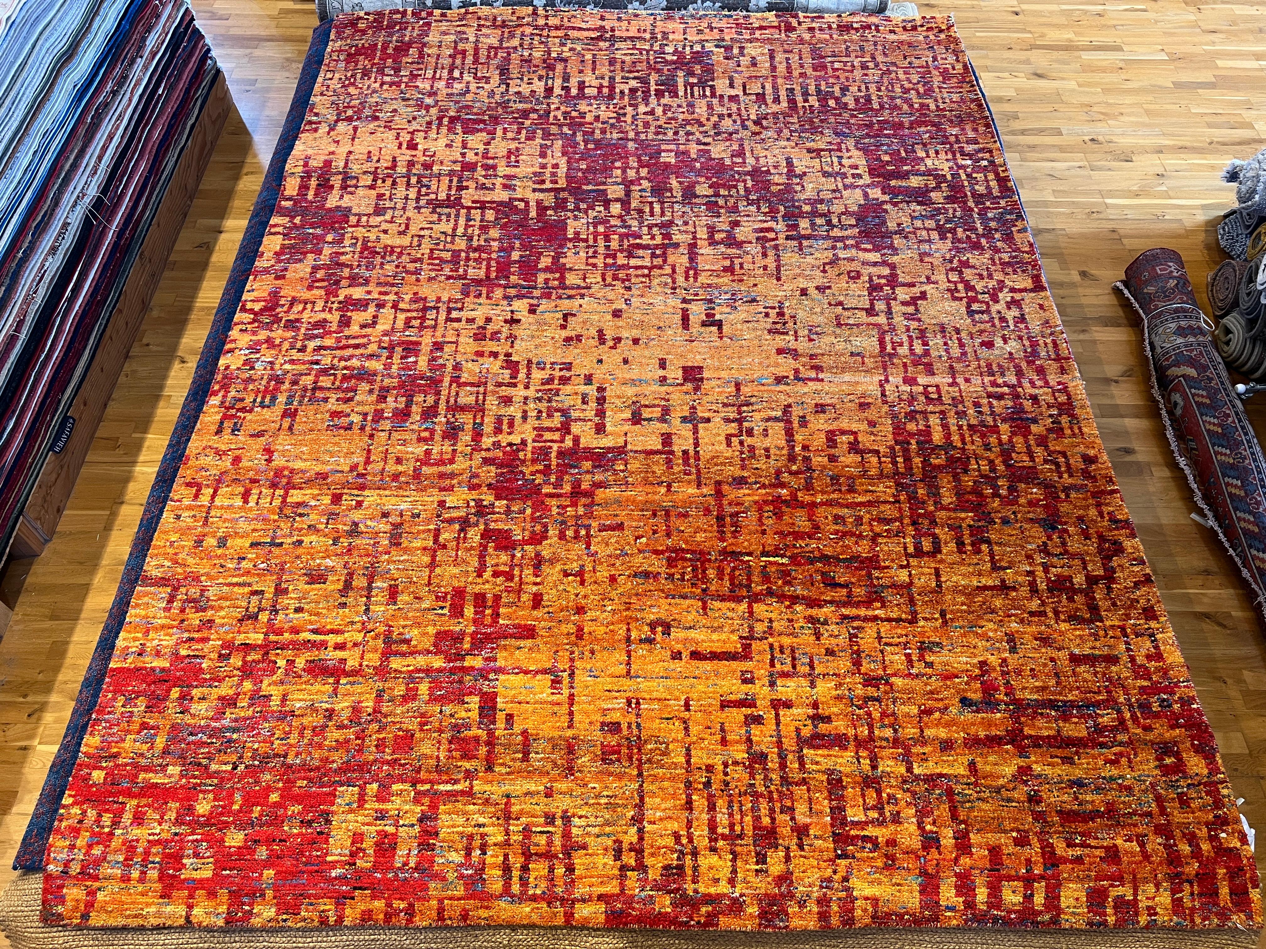 Add a pop of color to your living space with our 9'x12' Abstract Grunge Design Rug. The warm tones of red and orange create a vibrant and modern look, while the abstract design adds a touch of uniqueness. Made with high-quality materials for lasting