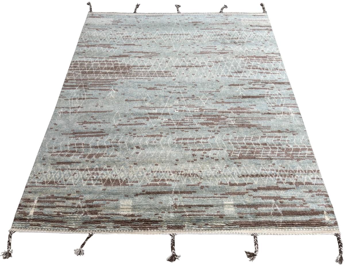 Eleva il tuo spazio abitativo con il fascino squisito di questo nuovo tappeto moderno annodato a mano in berbero marocchino Beni Ourain, realizzato con precisione e cura in lana al 100%. Combinando il fascino del design marocchino con la sensibilità