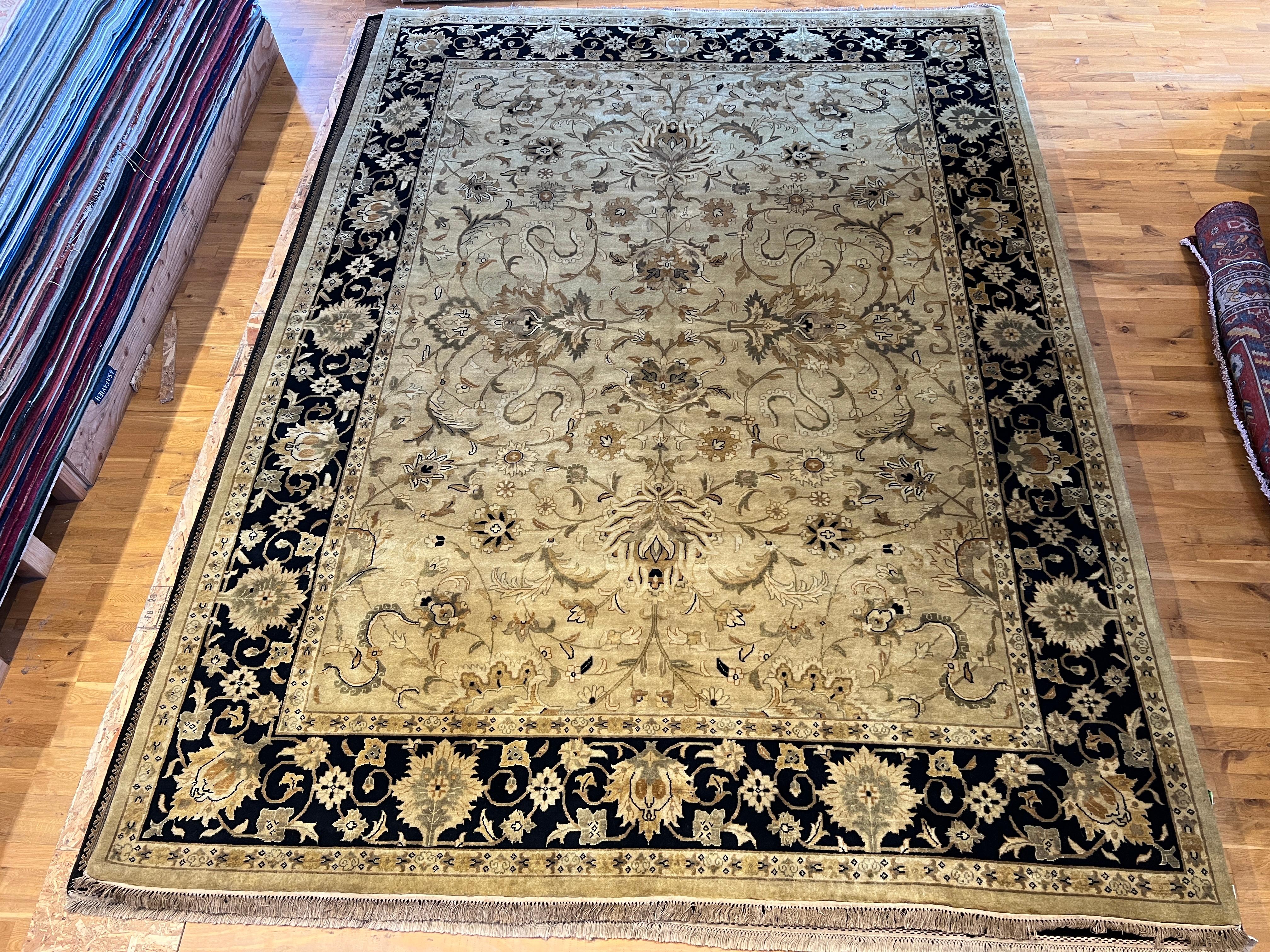 Introducing our beautiful 9'x12' Persian design rug, hand-knotted in India using all wool and natural dyes. Featuring a modernized black border and ivory field, this rug will add a touch of elegance and sophistication to any room. Experience the