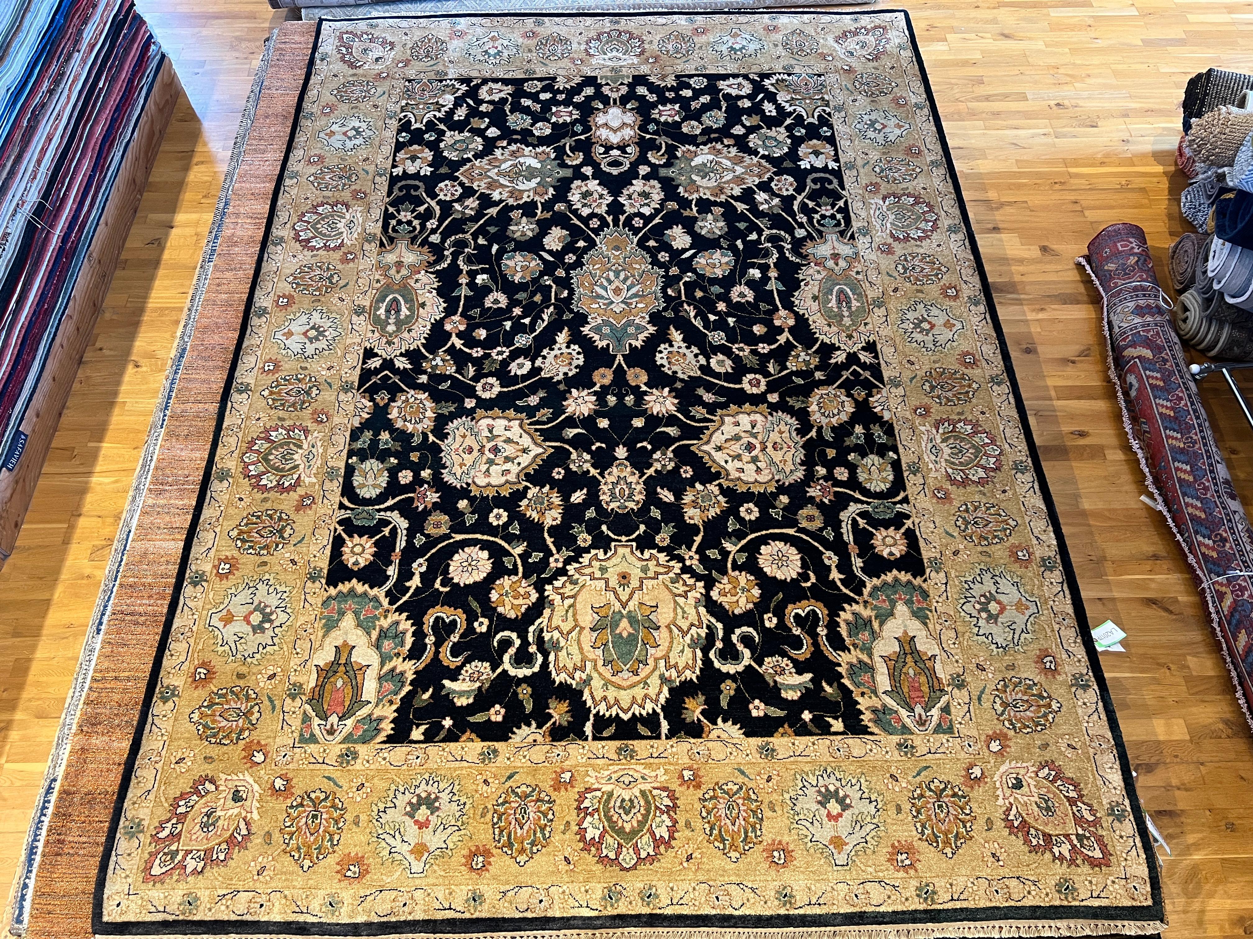 Introducing our beautiful 9'x12' Persian design rug, hand-knotted in India using all wool and natural dyes. Featuring a modernized black field and ivory border, this rug will add a touch of elegance and sophistication to any room. Experience the