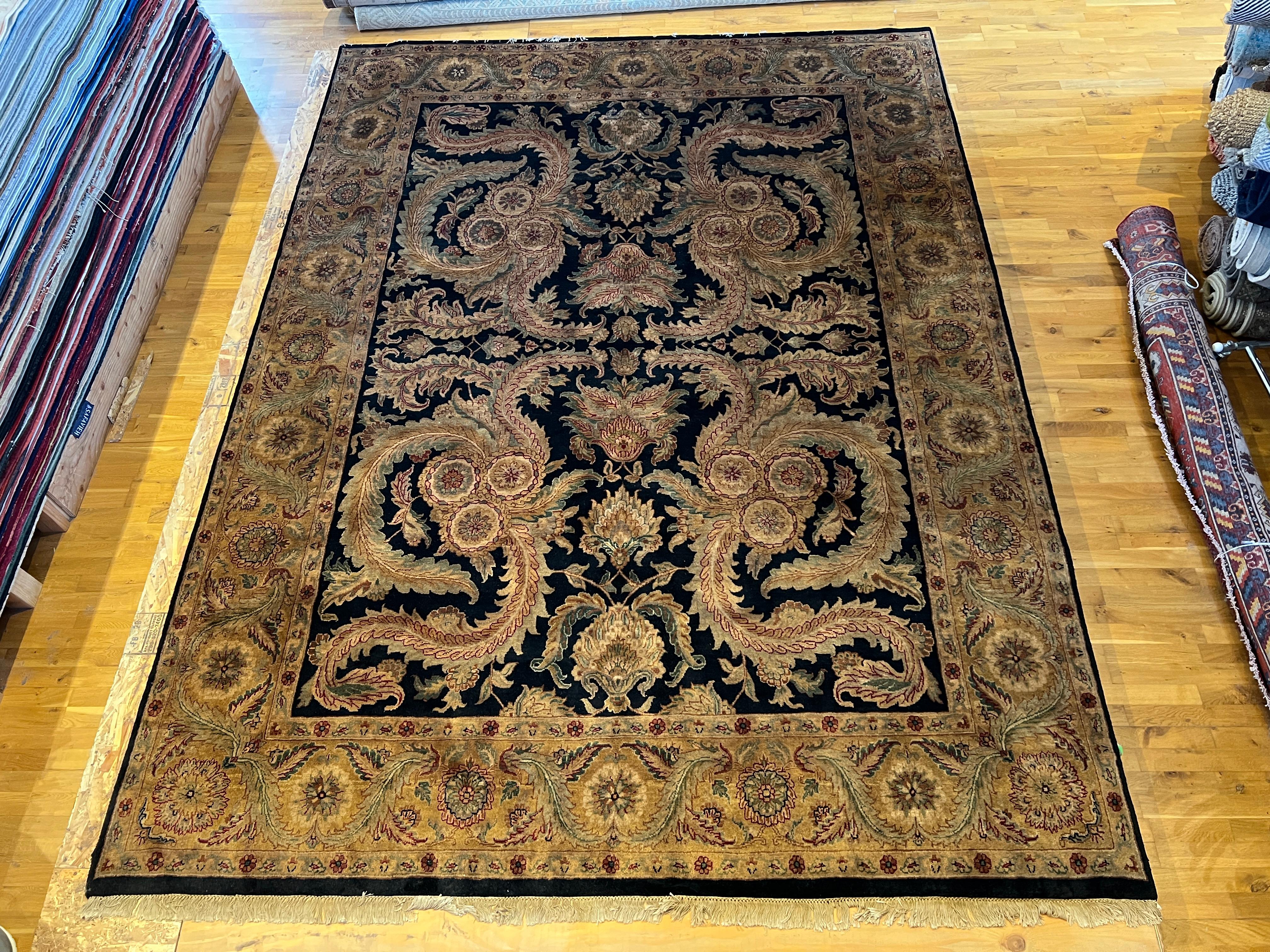 Introducing our beautiful 9'x12' Persian design rug, hand-knotted in India using all wool and natural dyes. Featuring a modernized black field and ivory border, this rug will add a touch of elegance and sophistication to any room. Experience the