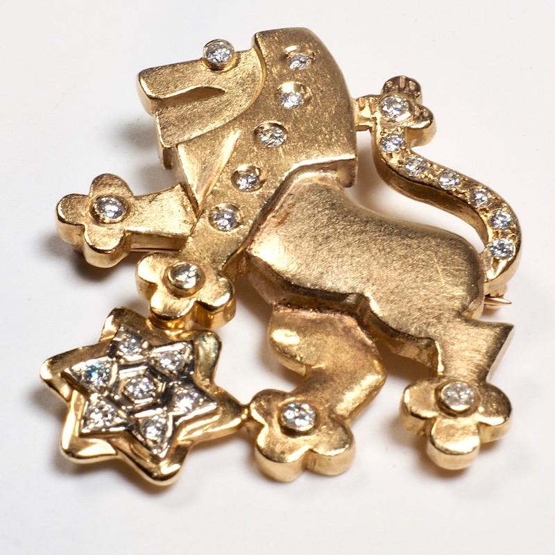 A 14K gold and diamond pendant brooch depicting the lion of Judah set with full cut diamonds 8.9 dwt 

