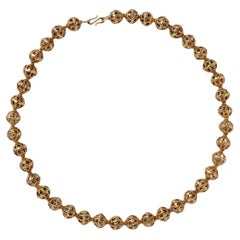 A 14k Gold Open Worked Bead Necklace