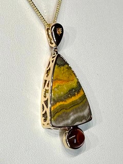 A 14kt Yellow Gold Pendant with Sapphire, Jasper & a Spessartine Garnet Cabochon