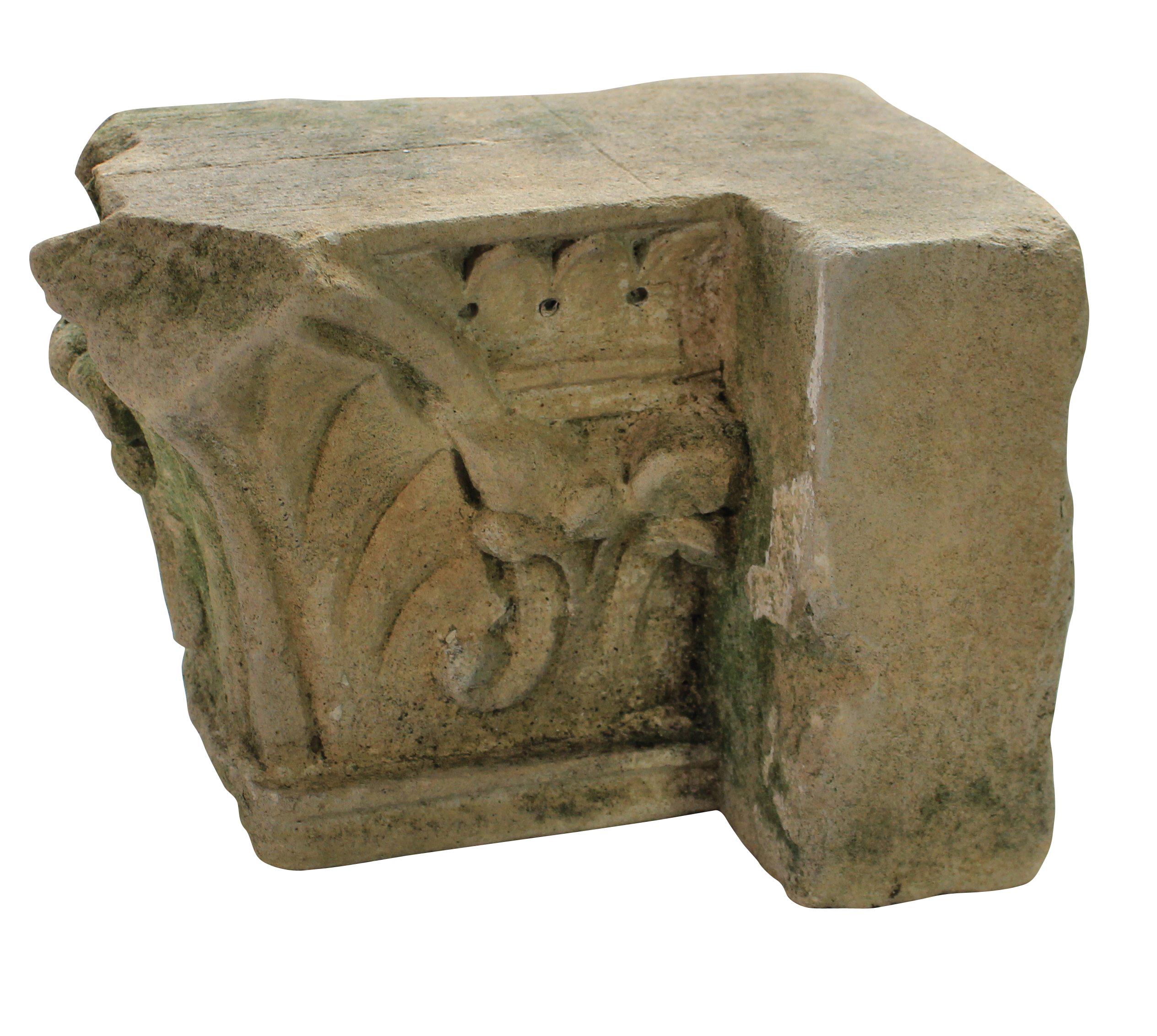 An English classically carved limestone architectural fragment depicting acanthus with traces of paint.
 
