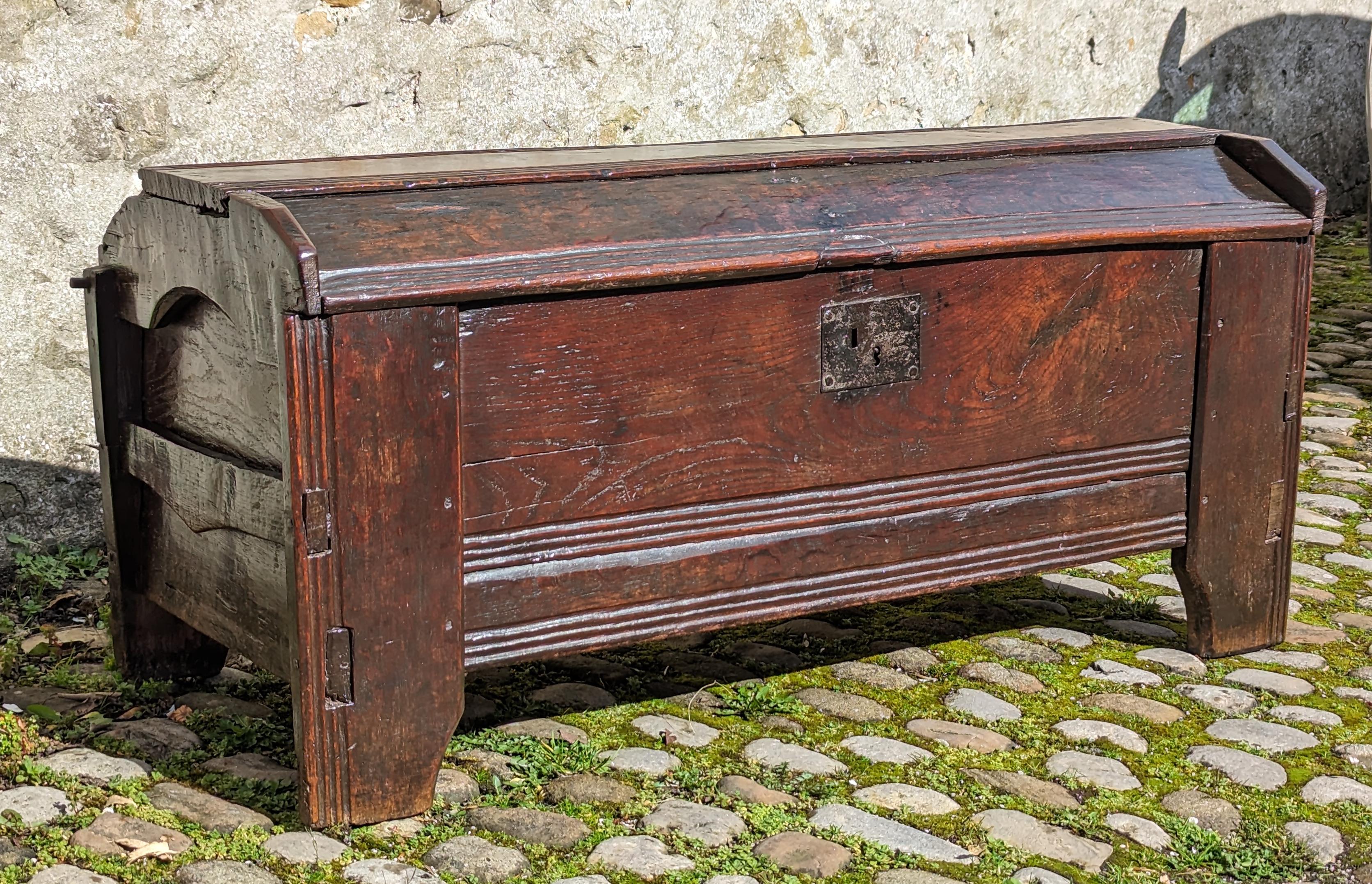 A 16th century boarded oak clamp-front meal chest or ark, Welsh Borders, circa 1550
Having a typical dome-lid constructed using three overlapping boards wedged and tenoned into the upright and extended shaped-ends.
Fantastic colour and surface, good