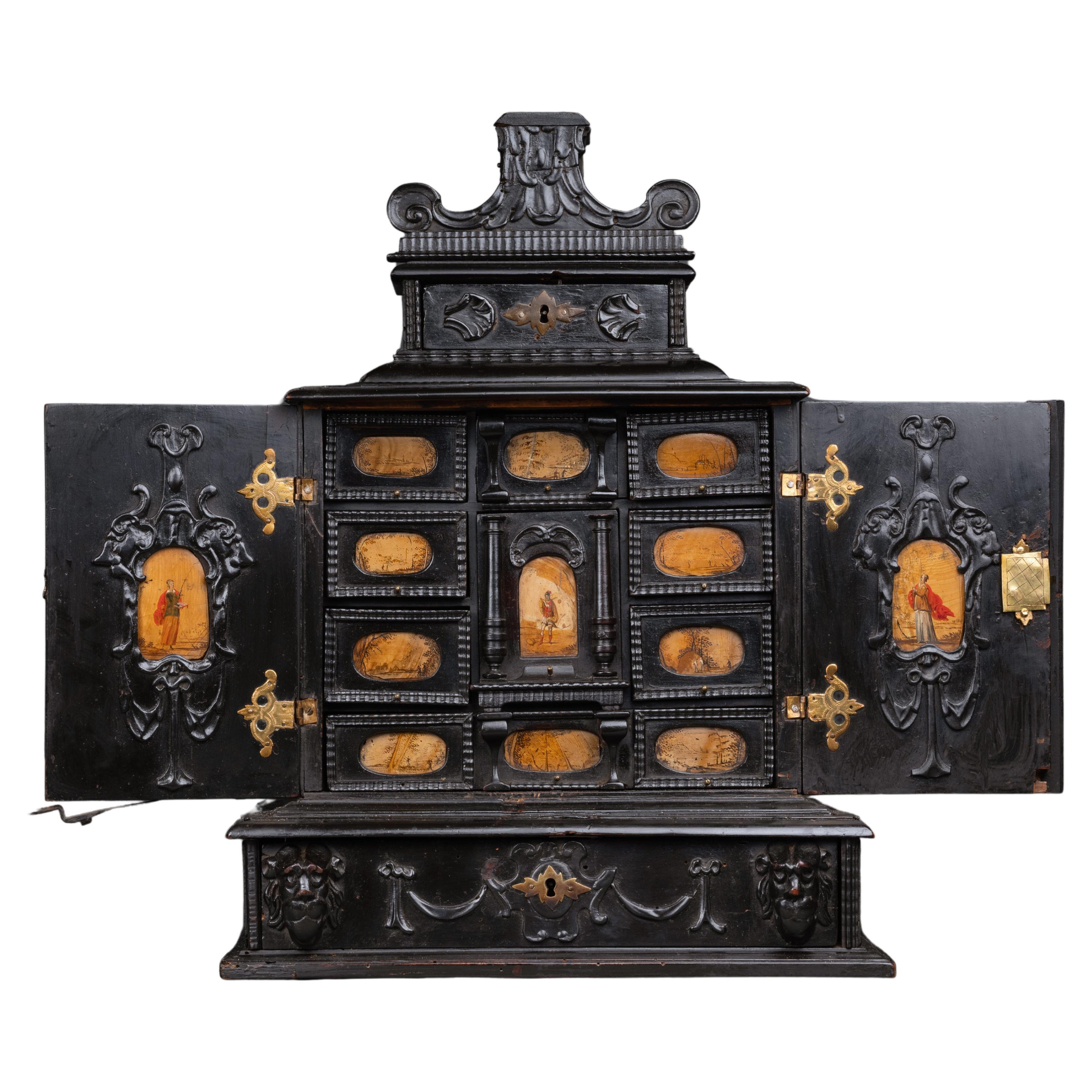 A 17th century Augsburg ebonized cabinet with painted pietra paesina panels