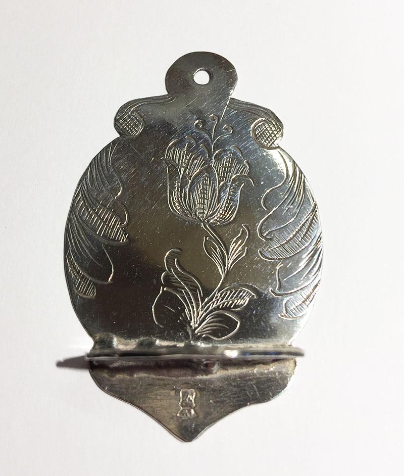A 17th century Dutch miniature dollhouse silver spoon rack

Engraved with tulip motif and engraved on the back the year 1693

The silver hallmark in the rack is the silver hallmark crowned shield with the letter V
And in the small spoons is the