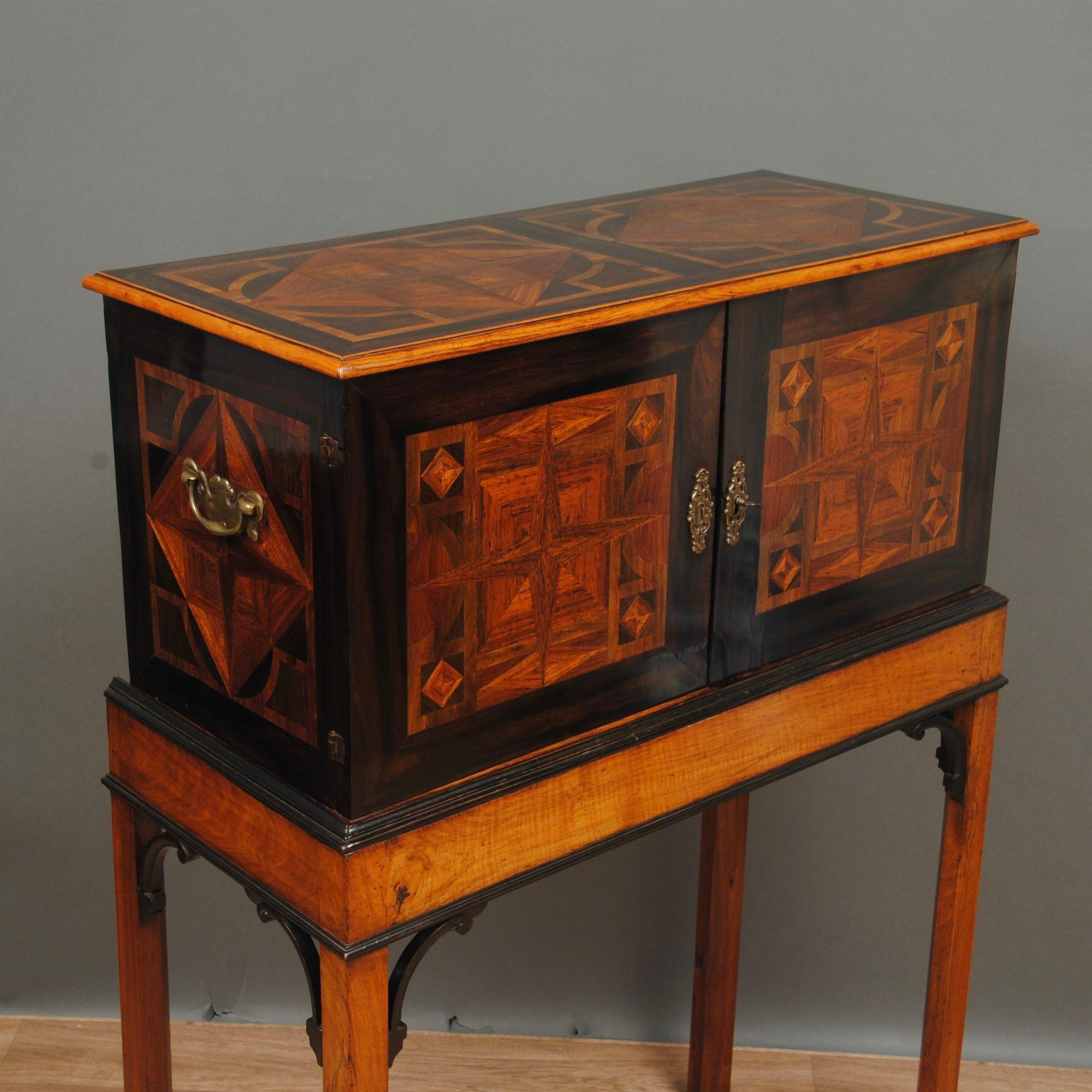 A fine 17th century german table cabinet with geometric marquetry inlaid to the cabinet in kingwood, decorated on the sides and top. the doors open to reveal a well fitted interior with drawers and central cupboard again all inlaid in geometric