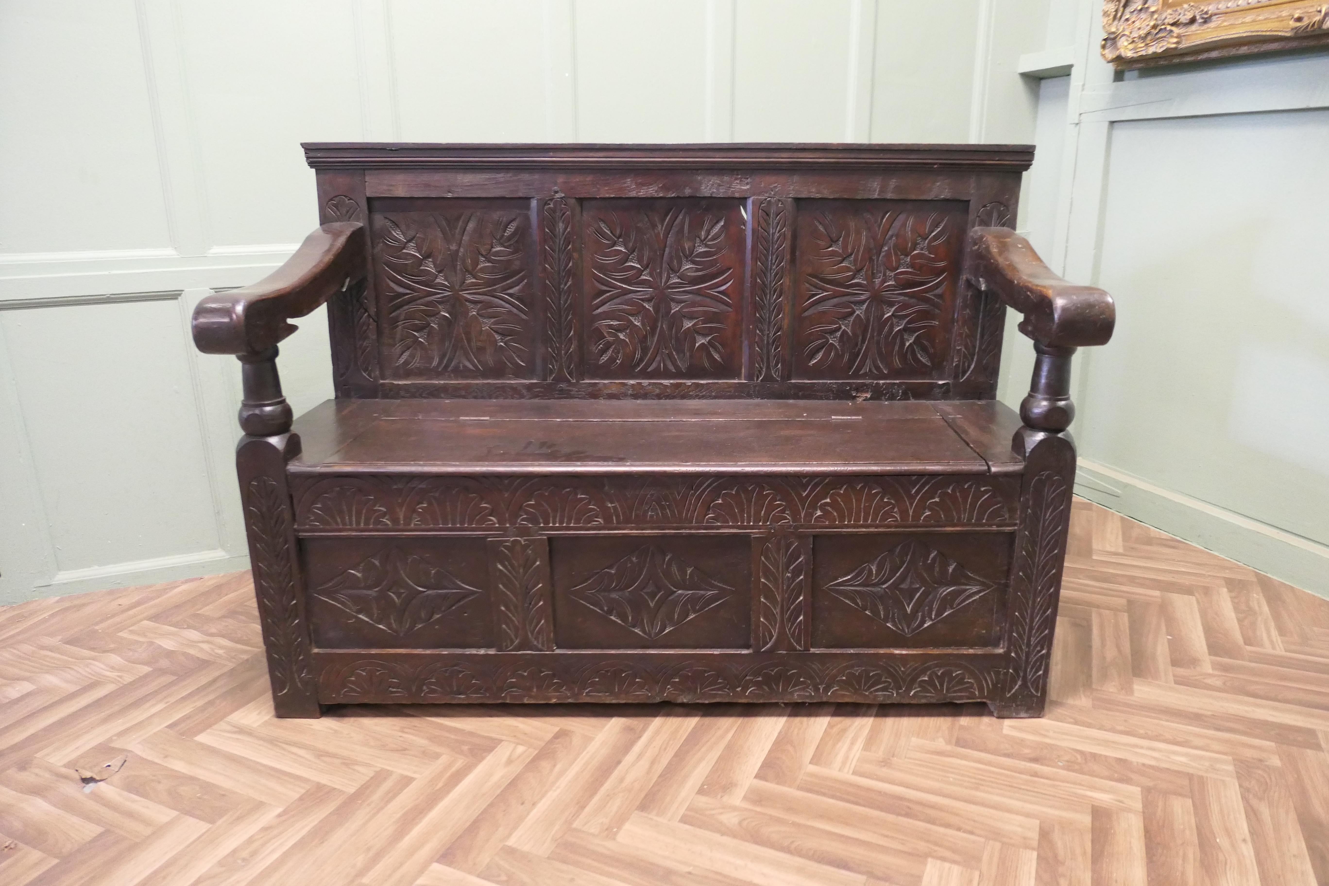 A 17th Century High Back Oak Box Settle

 The Settle has 3 carved back panels and further panels at the bottom the seat opens for storage
The bench is a real country piece with very wide chunky arms.
The settle is in good sturdy conditioned and has