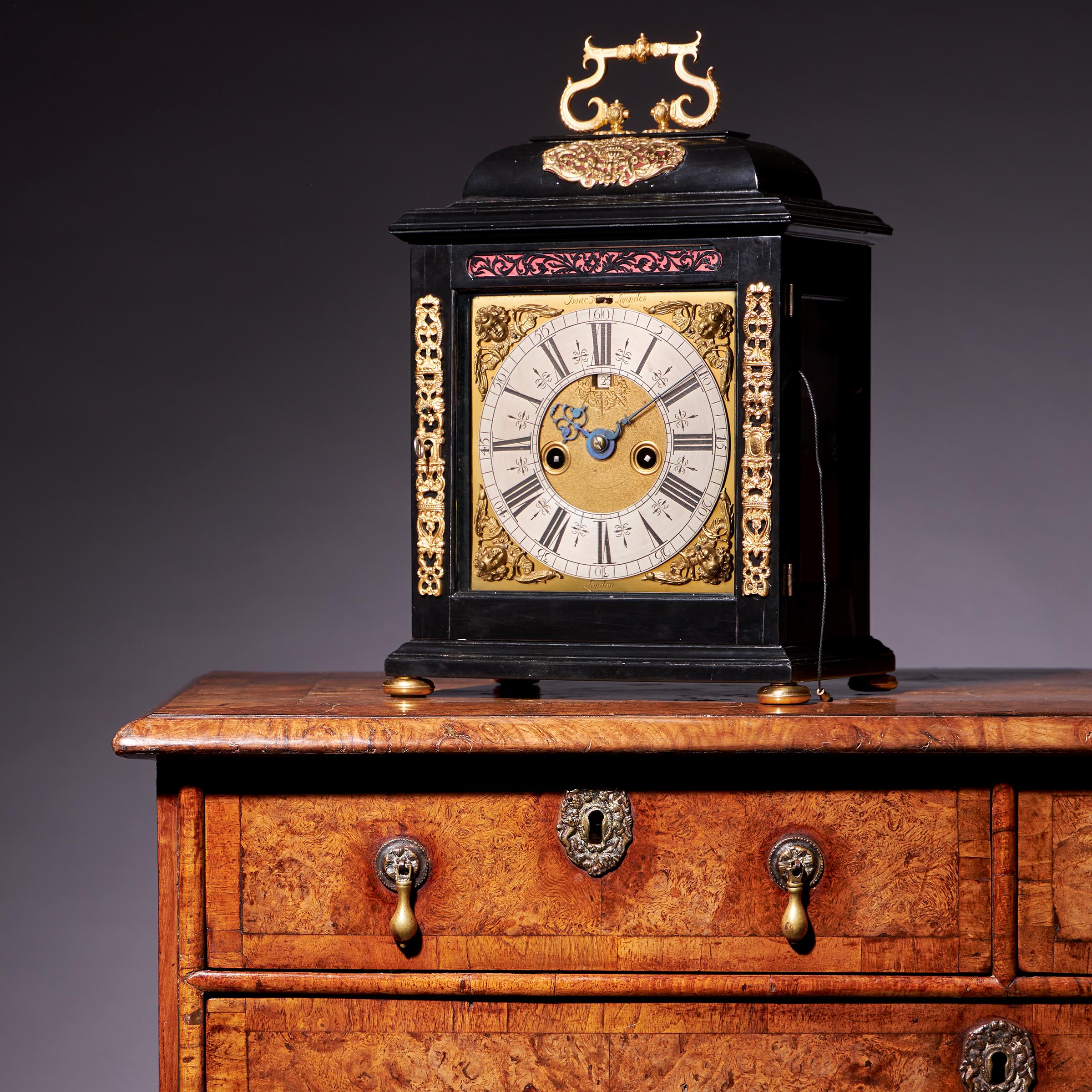 A fine William and Mary eight-day spring-driven table clock signed on the backplate, Isaac Lowndes Pallmall Court, c.1695. 

The elegantly proportioned ebony-veneered oak domed top case has large rectangular viewing windows to the sides so that the