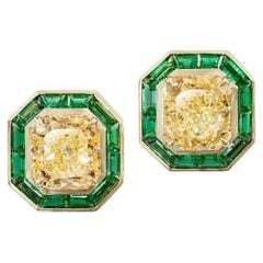 A 18 Kt Yellow Gold 6.02ct Earrings accompanied with emerald and diamonds