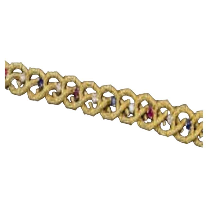 A 18 kt Yellow gold and diamond bracelet accompanied with sapphires and rubies For Sale
