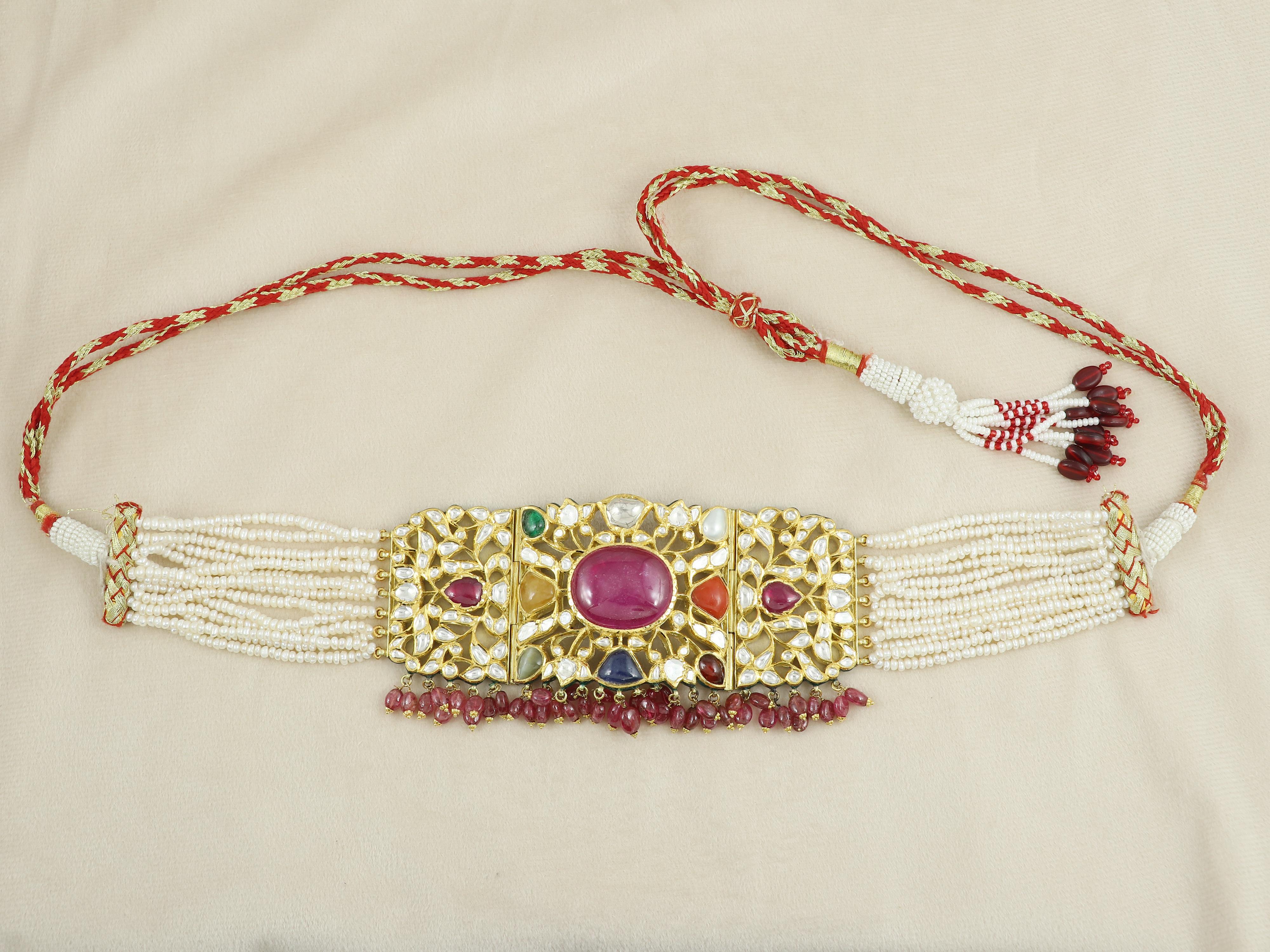 A necklace in the form of a collar compromising of nine precious gemstones, with centre as a big size Mozambique mines Bangkok ruby surrounded with eight other natural gemstones, emerald, diamond, pearl, coral, hessonite garnet, blue sapphire, cat's