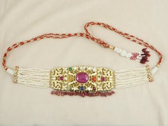 A 18K gold Indian wedding Navratna choker with nine gemstones and diamond polkis