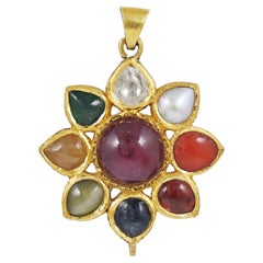 A 18K gold nine precious natural gemstones pendant, Indian navratna pendant