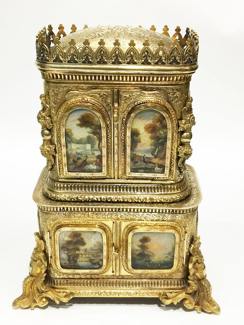 18th Century miniature bronze gilt cabinet

18th Century gilt Bronze Miniature, Gold Sewing tools Cabinet
A 18th Century bronze gilded miniature cabinet, sewing cabinet with painted scenes on reverse glass in the doors. The legs are in Rococo style