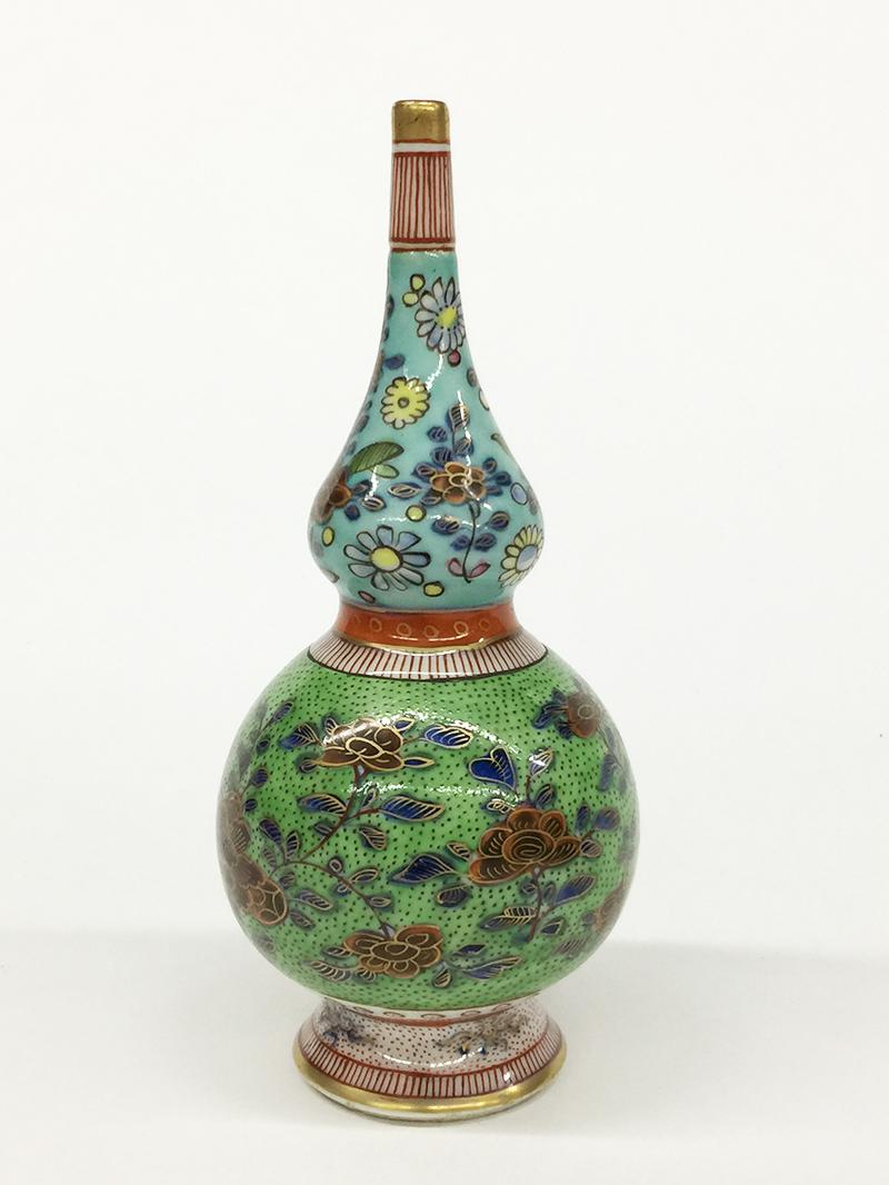 A 18th century Chinese porcelain colored double gourd vase in floral design, Kangxi.

A double gourd Chinese porcelain vase, raised on a round foot base from the Kangxi period 1662-1722
Richly colored with floral and leaves patterns
The measurements