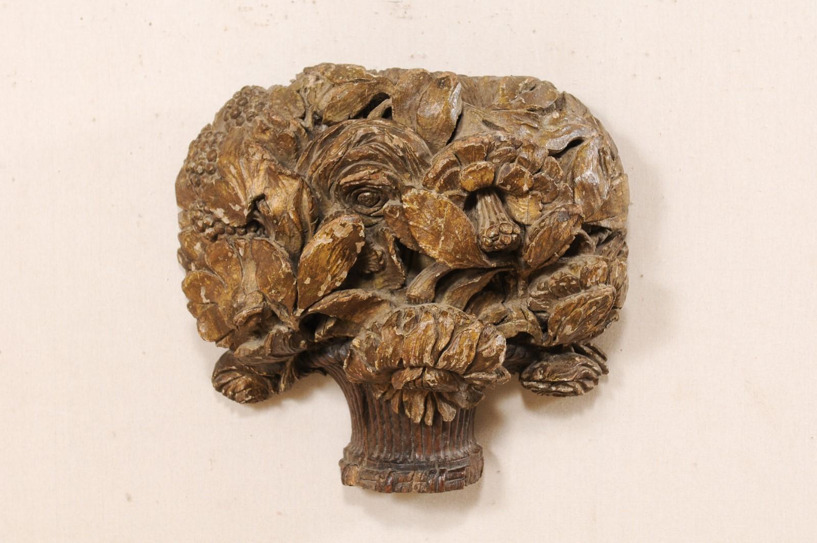 A French carved-wood bouquet wall plaque from the 18th century. This antique wall ornament from France has been fashioned out of a single piece of wood and features a bouquet-shaped body comprised of three-dimensional, hand carved flowers with roses