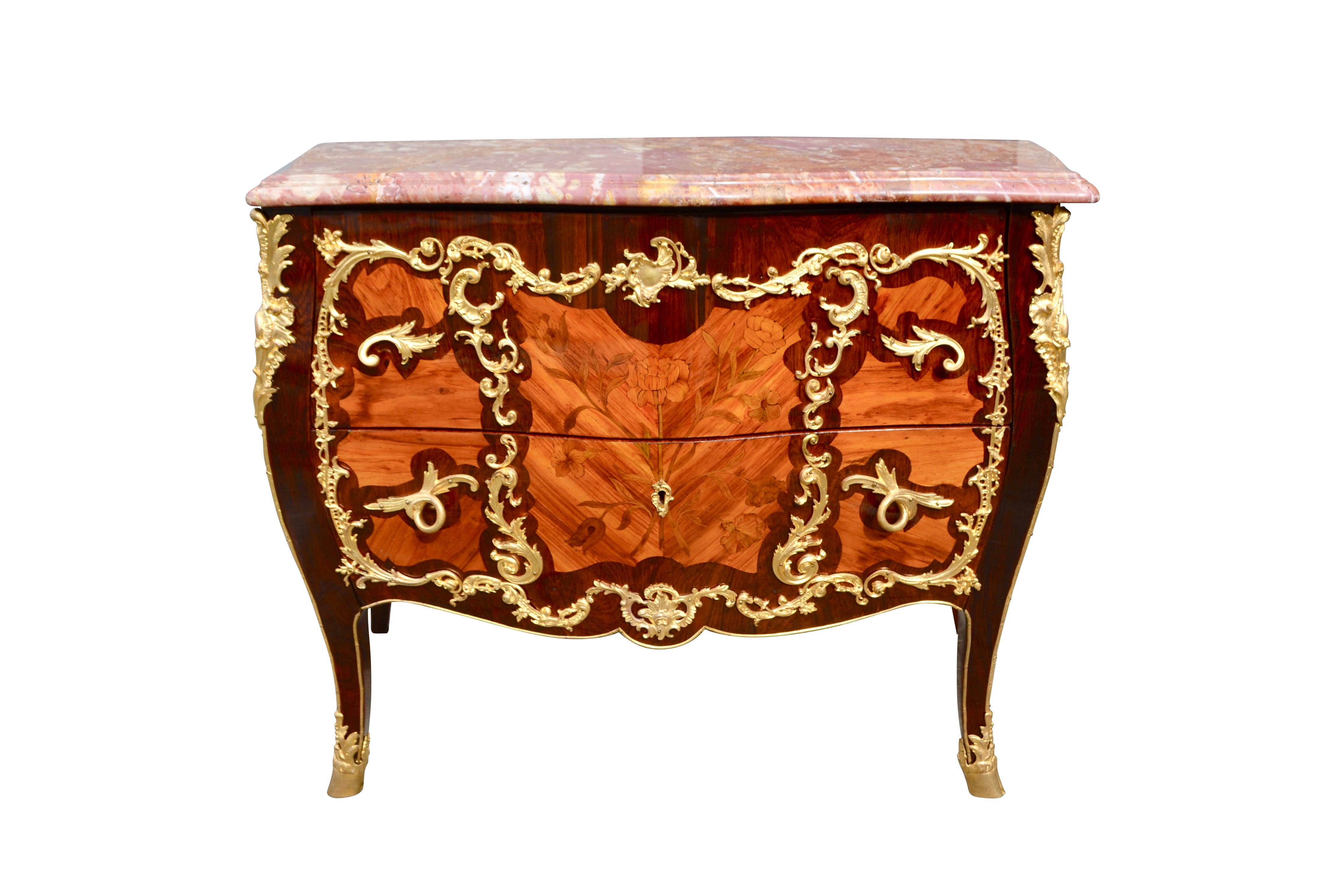 A very fine example of French 19th century Louis XV style Bombe two drawer chest commode. The oak carcass is veneered in kingwood and amaranth and inlaid with floral designs on the front. There is a inlaid radiating pattern of kingwood framed in