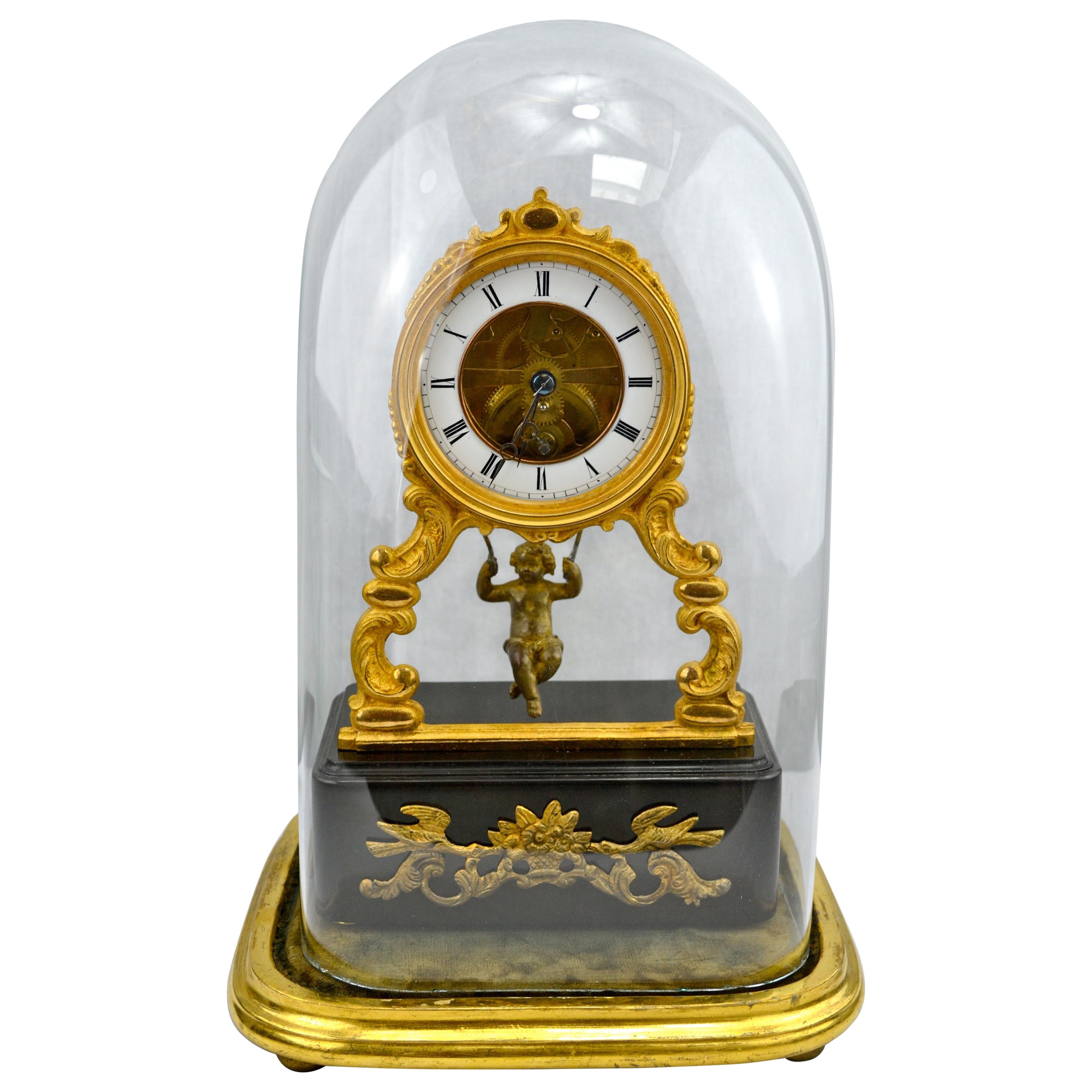 19th Century Glass Domed Gilt Bronze French Mystery Clock with a Swinging Putto