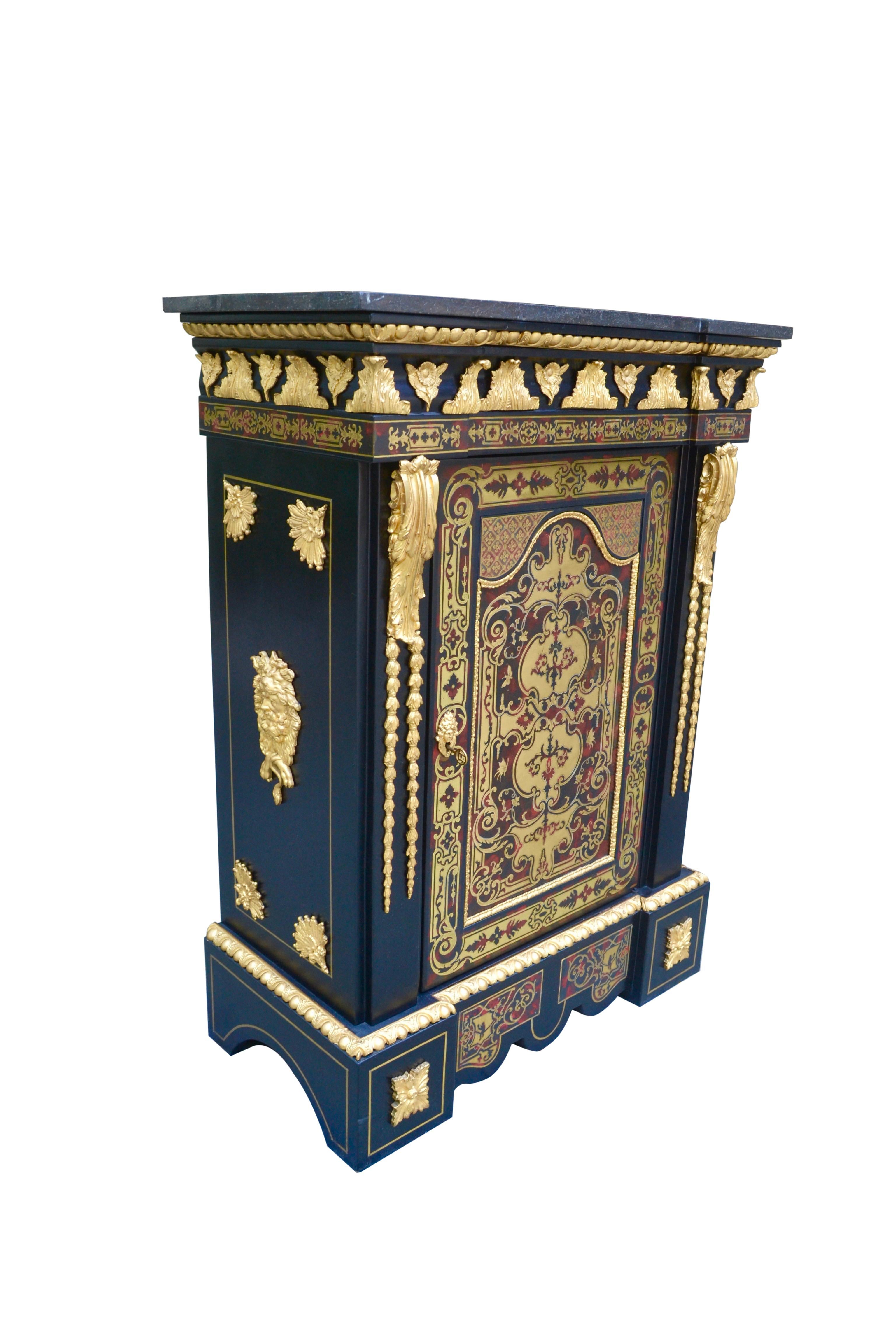 A very fine quality French cabinet referred to as a Meuble d'Appui. The piece was made in Paris during the reign of Napoleon III circa 1870. The ebonized cabinet is inlaid with brass and has all-over lavish gilded bronze mounts and mouldings. The