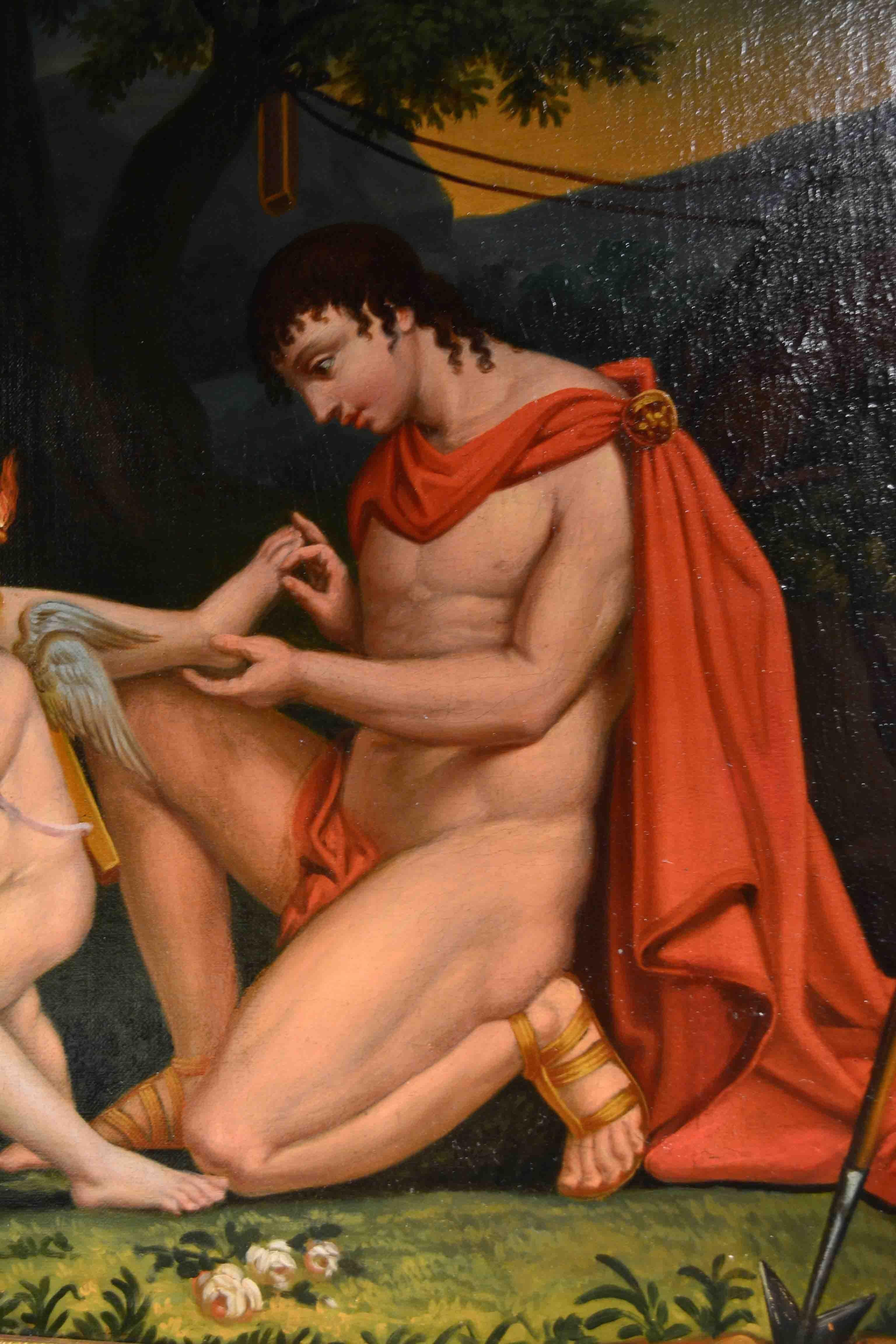 A 19th century neoclassical genre painting showing a draped Apollo kneeling in front of seated Diana pulling a thorn out of her foot, between them cupid is standing holding a flambeau, The unsigned painting which has been recently restored, was