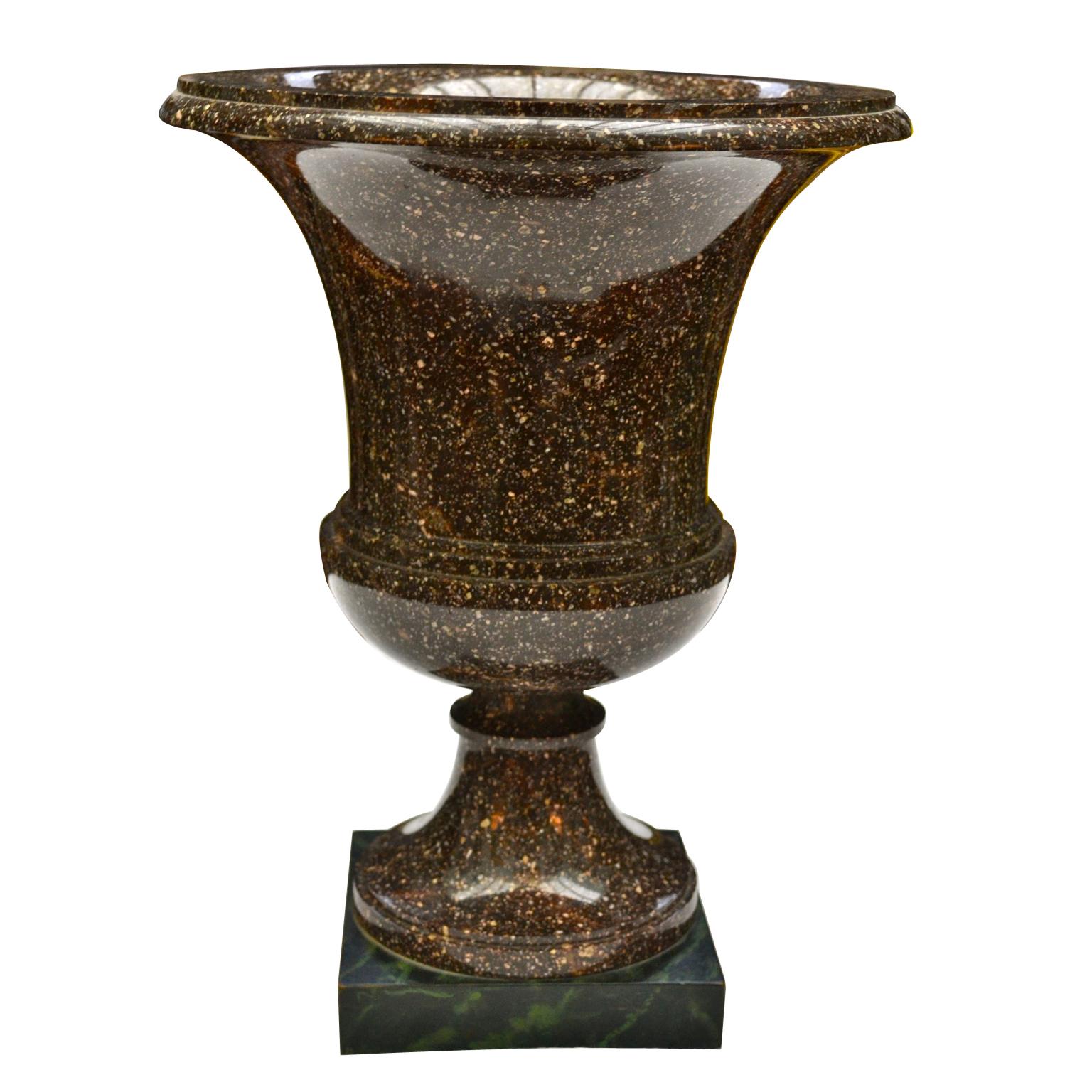 An early 19th century Swedish or Russian Porphyry campana urn vase carved in a Classic shape, likely carved by the Alvdalen factory in Sweden, the vase presently mounted on a faux green marble rectangular base,