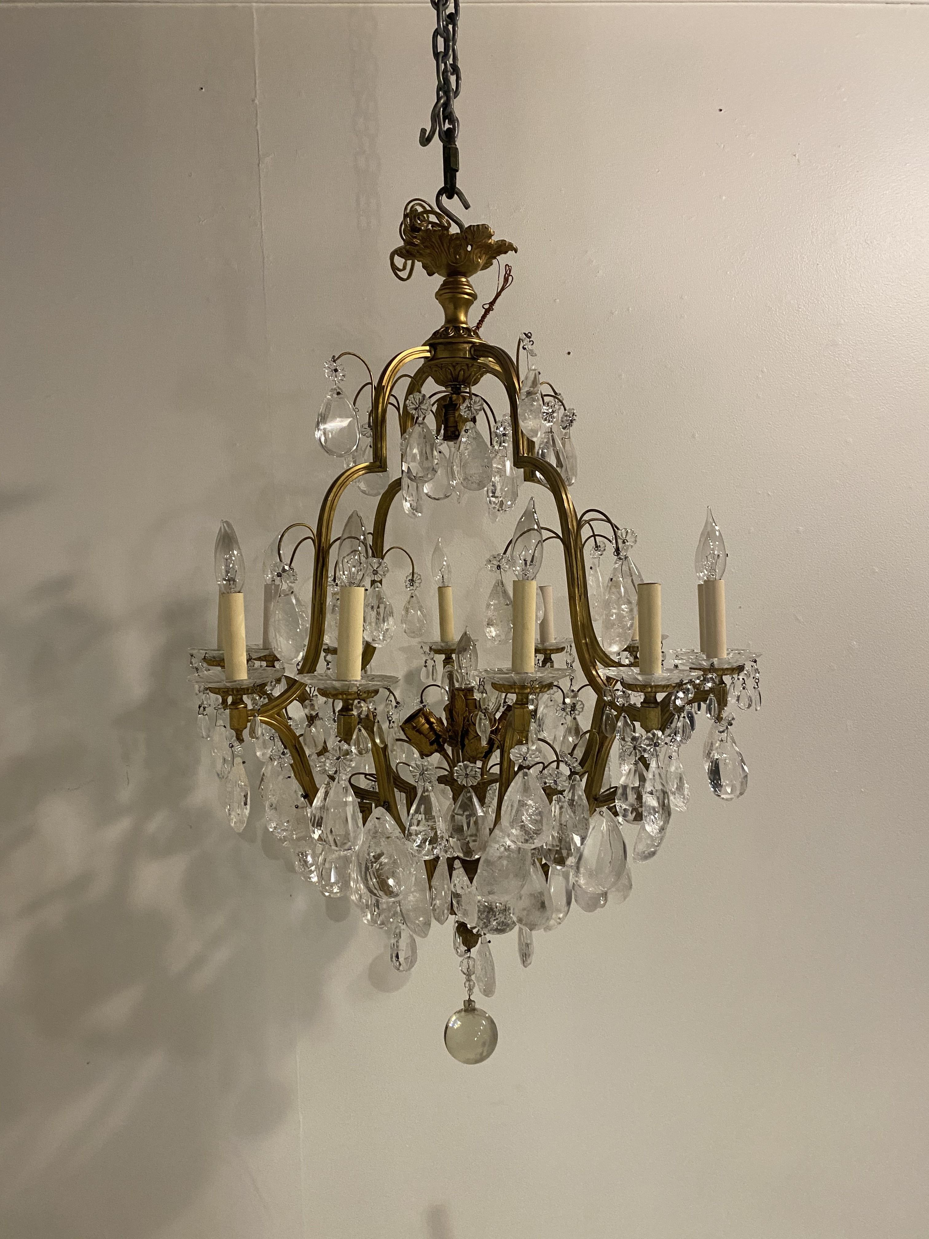 A circa 1900's French gilt bronze chandelier with rock crystal hangings (12 arms and 6 interior lights.).