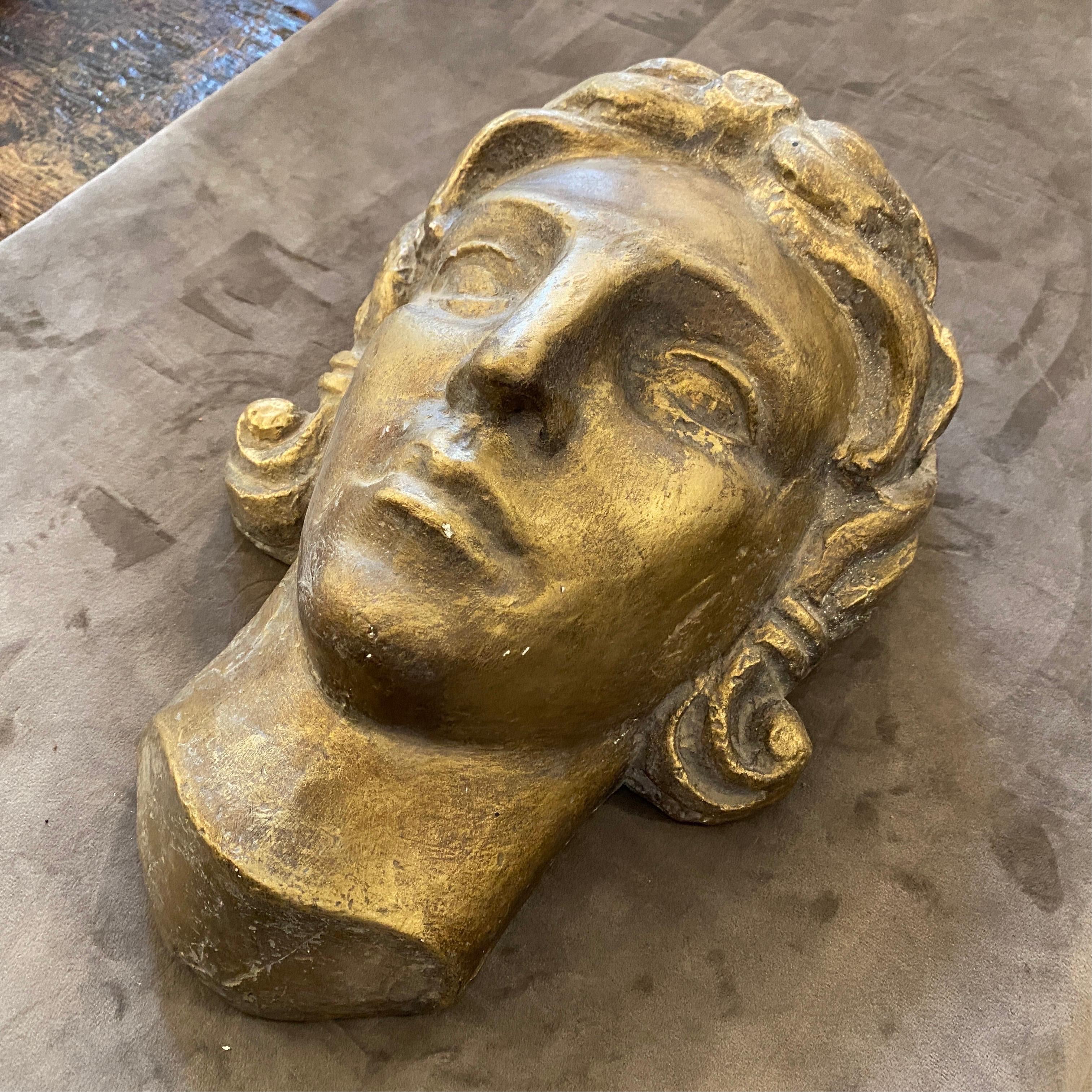 An Art Deco plaster head depicting a face of a woman or a young boy. It has been made in Italy in the 1930s.