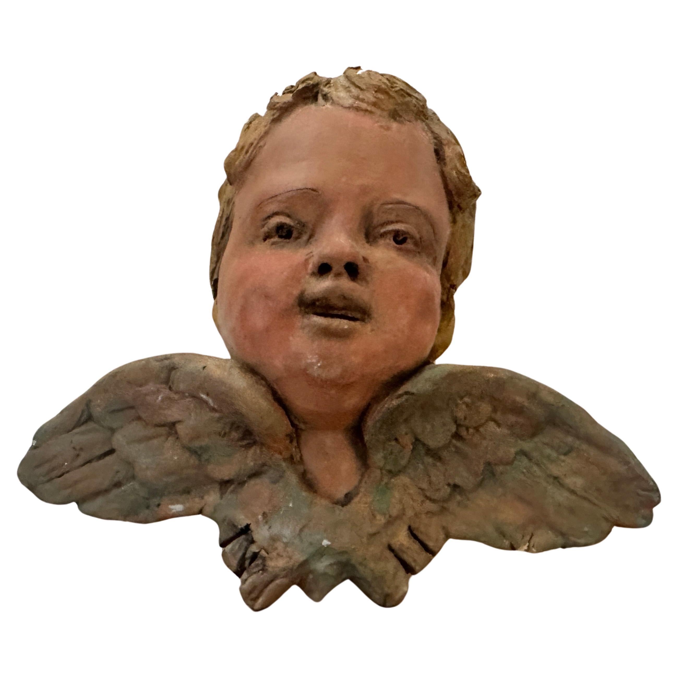 A painted terracotta putto hand-crafted in Sicily in the first half of 20th century in the town of Caltagirone world famous for hand-crafted ceramics. This Angel has normal signs of use and age. The Baroque style originated in Italy in the early