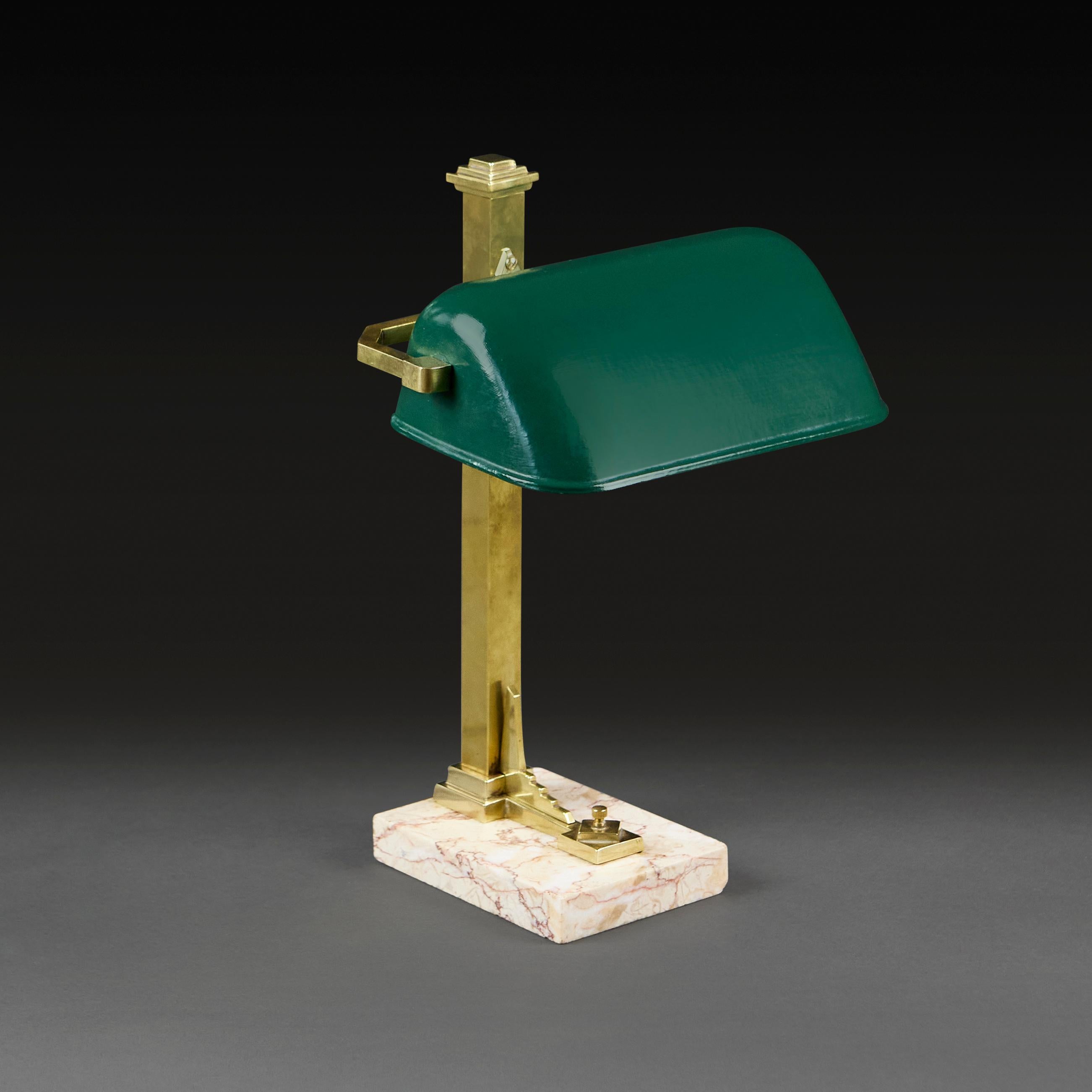 France, circa 1930
A fine Art Deco French desk lamp, with adjustable green enamel shade, and rectangular marble plinth base, the brass with stepped decoration to the top and the base.

Height      37.00cm
Width       28.00cm
Depth     