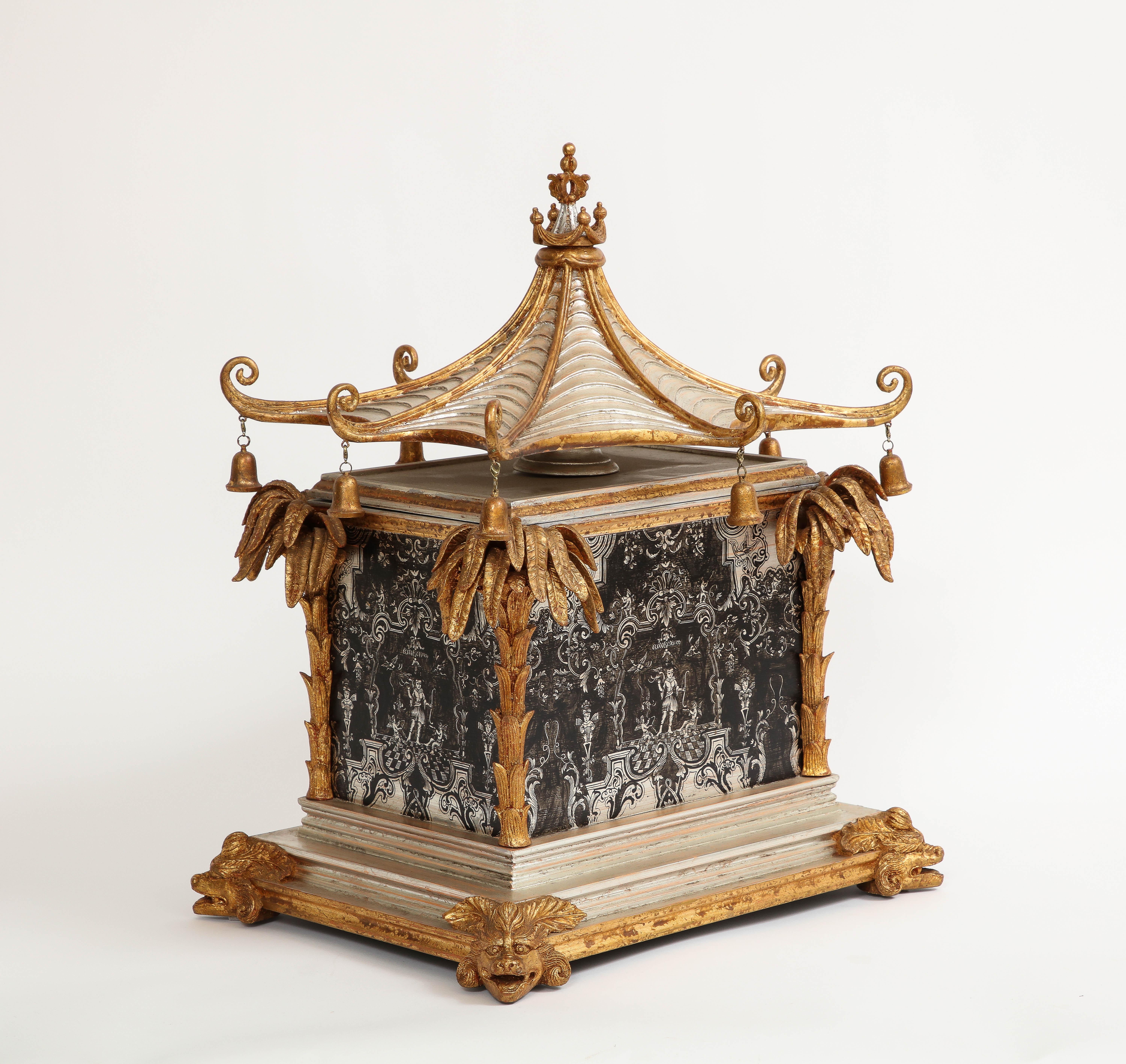 A 1930's French Gilt Lacquered Wood Pagoda Form Chinoiserie Platinum Painted Box, Attributed to Jansen. At first glance, the box's visual allure is simply breathtaking. Adorned with meticulous hand-carved and hand-painted details, this remarkable