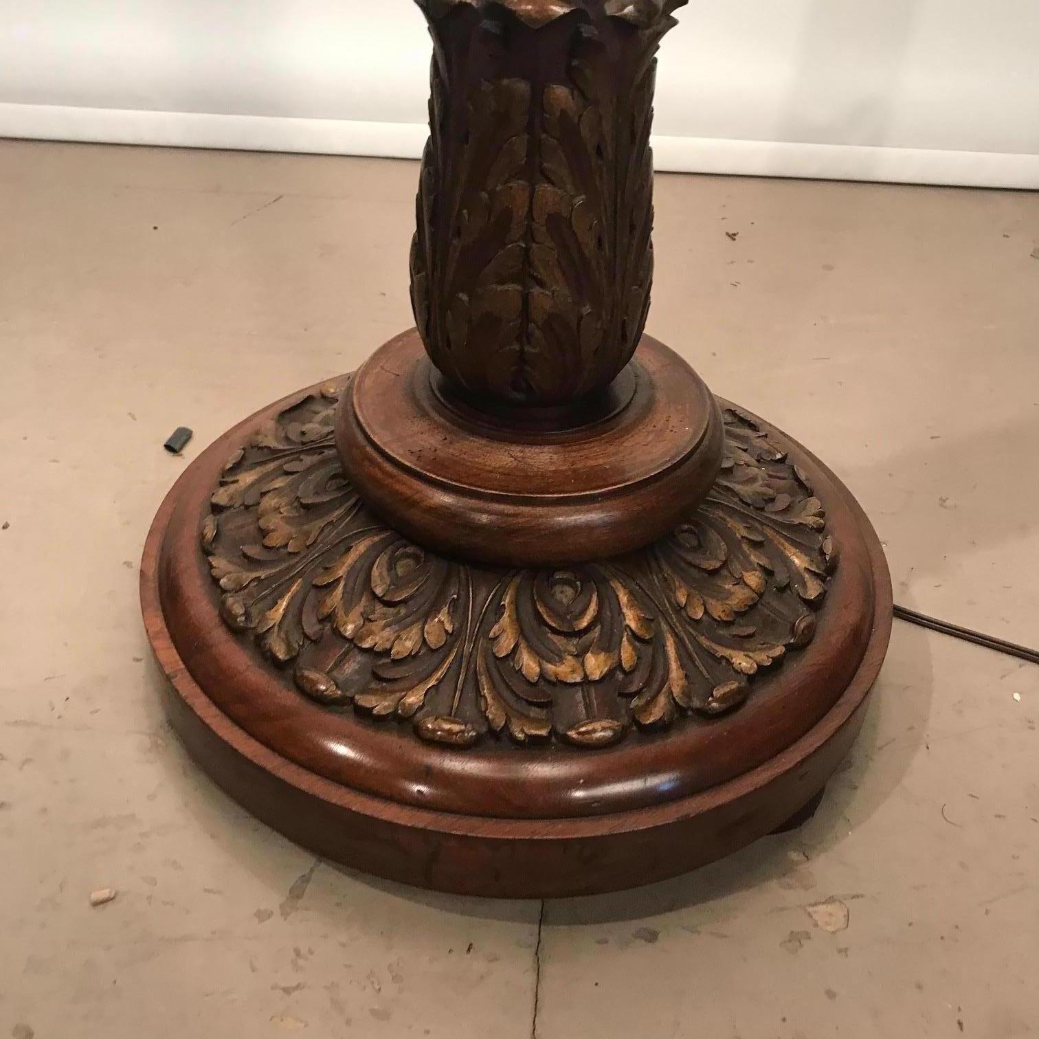 The circular base is well-turned and applied with hand carved acanthus with gilt highlights. The tapering stem is fluted providing an added elegance. This lamp seems to us to date from the 1930s. It is no longer easy to find a lamp of such quality.