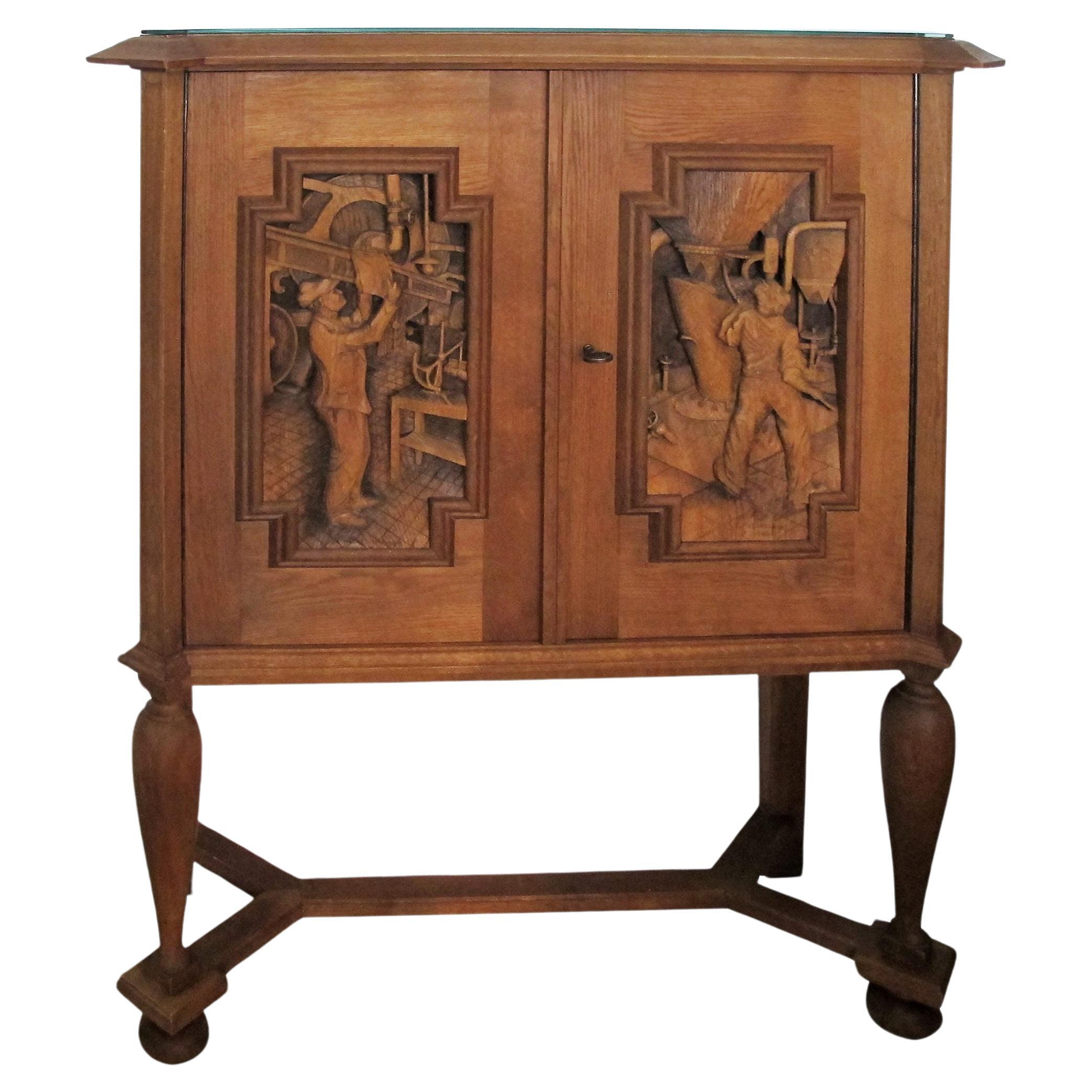 A 1940’s E. Hallanvaara oak cabinet with carvings on the doors, Finnish  For Sale