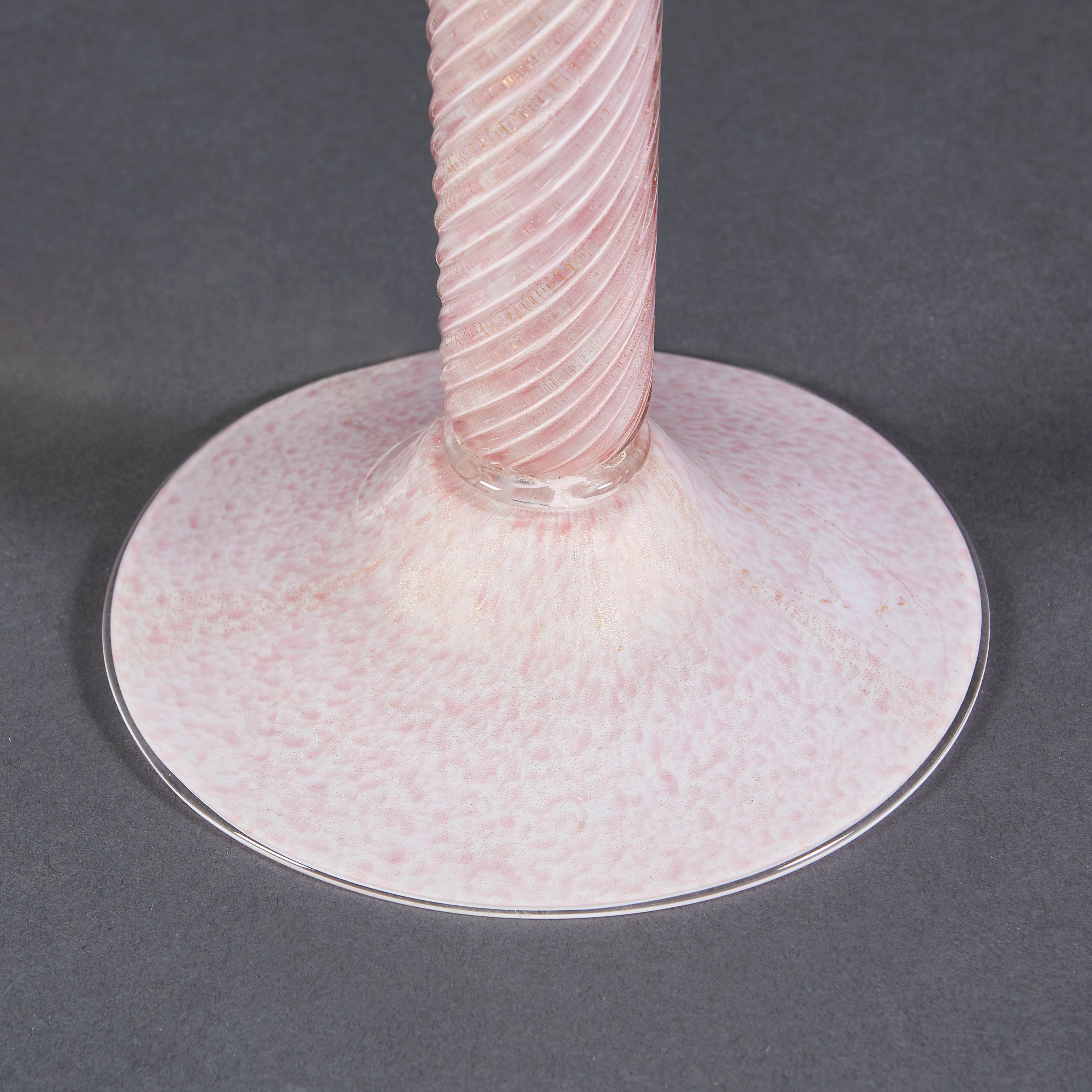 A Murano glass column lamp, composed of pale pink glass, the stem twisted in a spiral form, supported on a disc shaped base of mottled pink glass.

Please note, lampshade not included.

Currently wired for the UK.