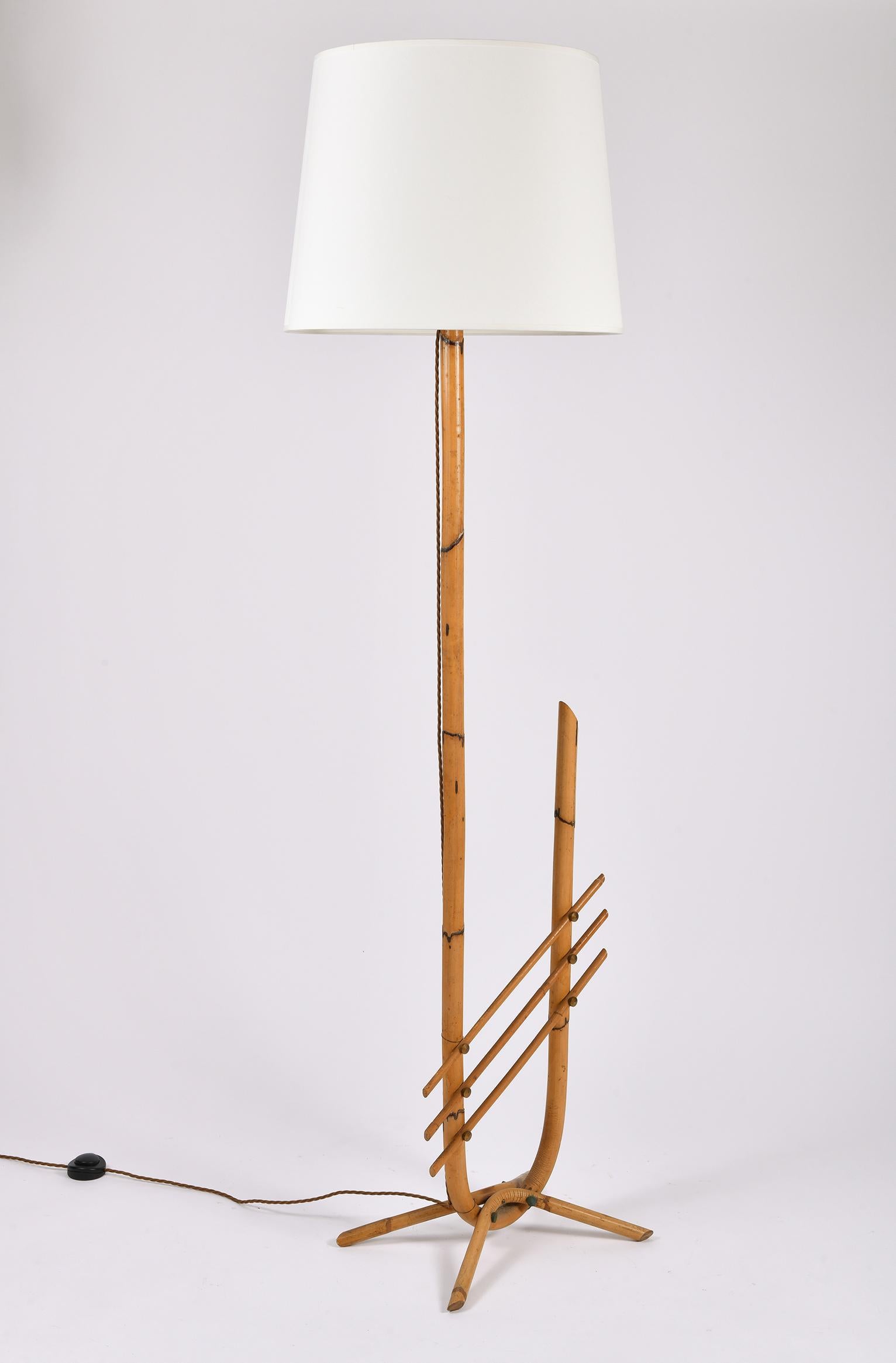 A brass mounted steam bent bamboo floor lamp.
France, circa 1955
The stated dimensions are. including the shade.