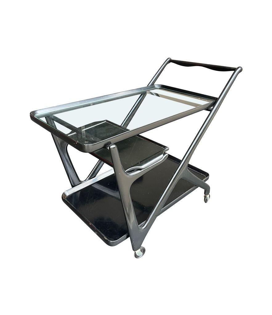 A 1950s cart trolley in black lacquer by Ico Parisi with the top two trays being removable serving trays with orignal castors.