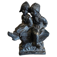 A 1950s Black Painted Terracotta. Dutch Figure of Two Childs