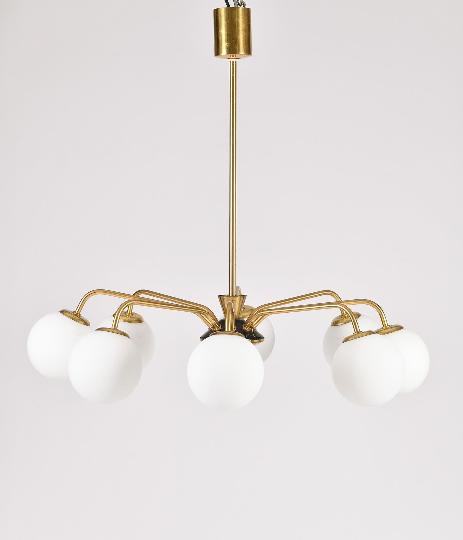 An eight armed brass, black enameled iron and matt opaline glass globe chandelier
Sweden, circa 1950.