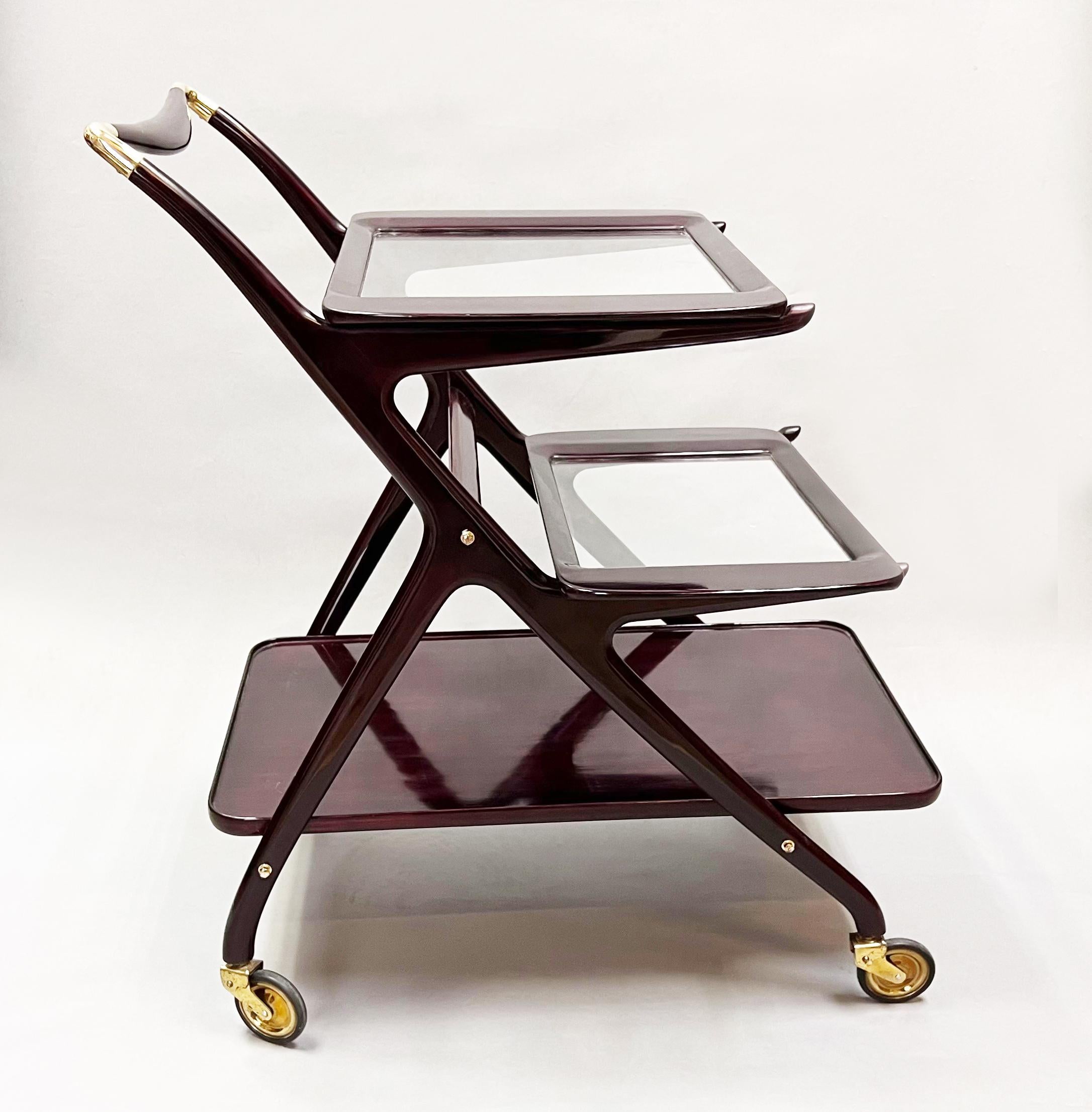 A 1950s Cesare Lacca bart cart trolley lacquered mahogany with removable glass trays with brass detailing and orignal brass castors, for Italian company Cassina.