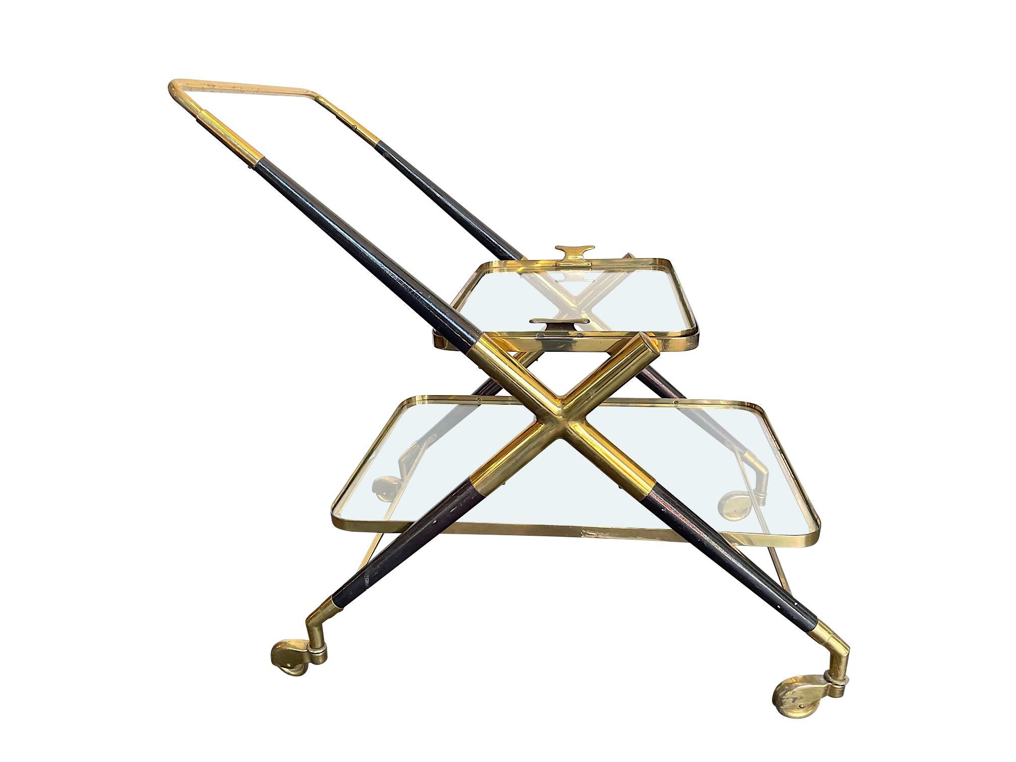 A 1950s Cesare Lacca brass and black lacquer bar trolley with removable brass tray and 