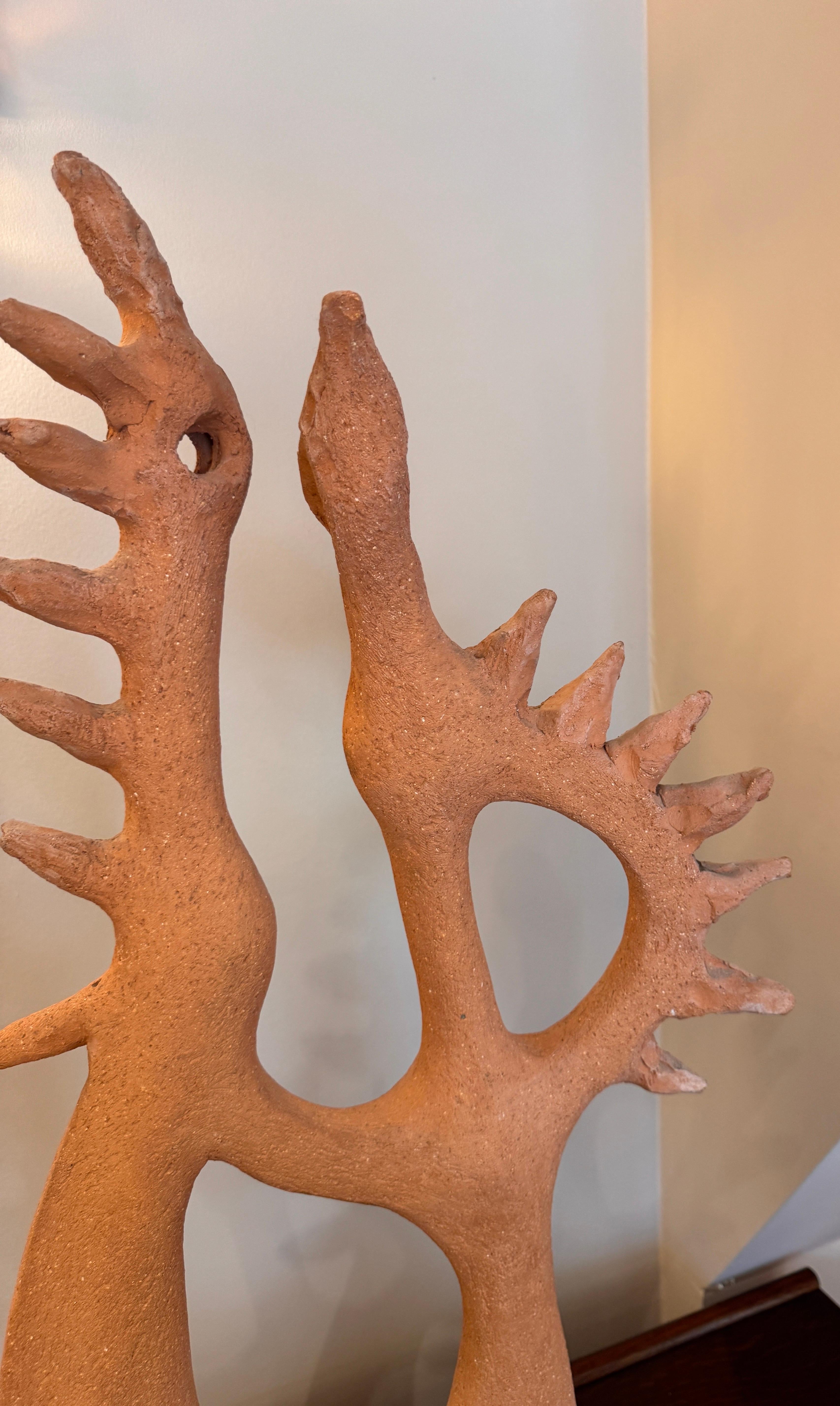 A large abstract terracotta sculpture of two feathered birds in the style of Picasso. Signed Toma . 
France C1950 