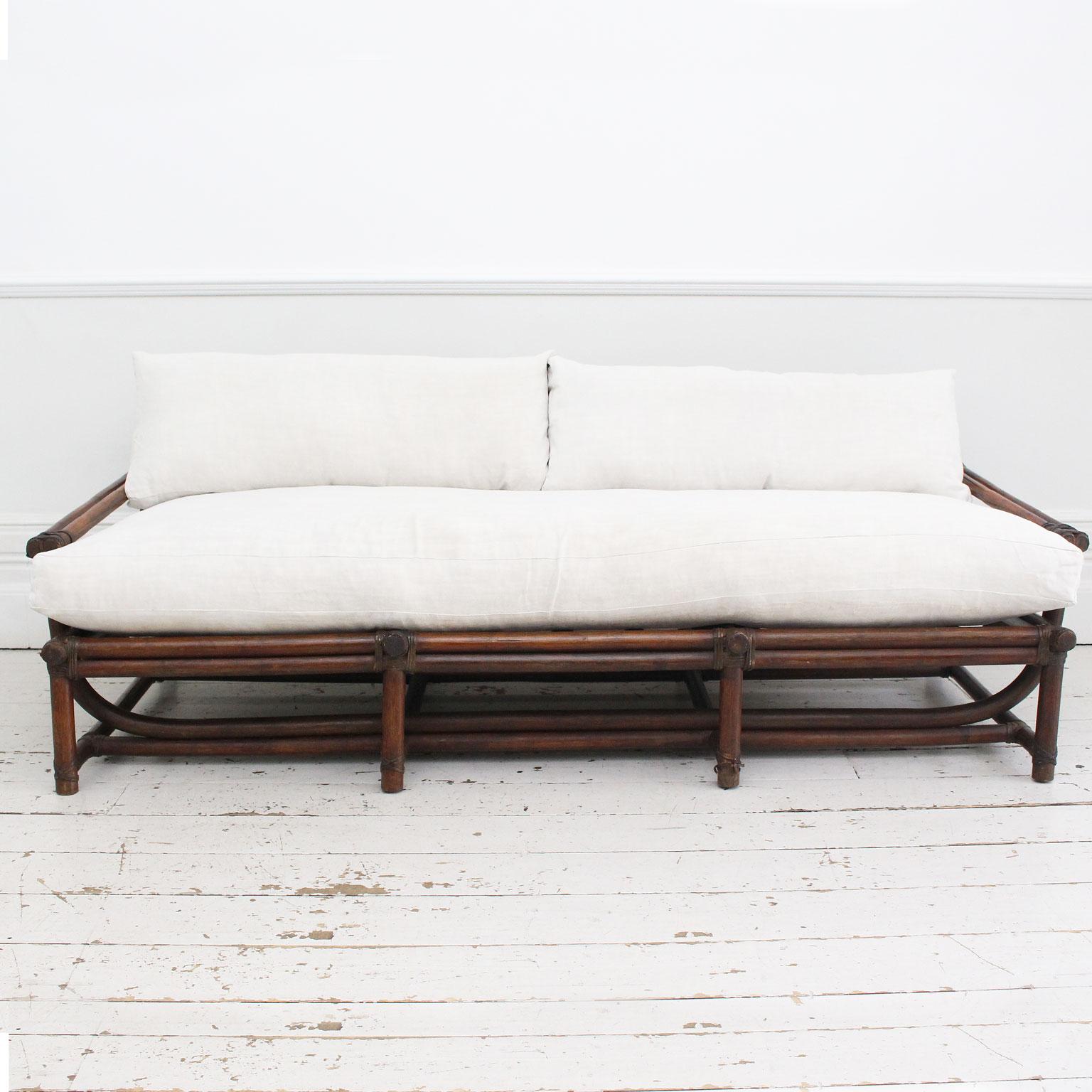 Mid-Century Modern A 1950's French Dark Bamboo Sofa with Antique Linen Cushions