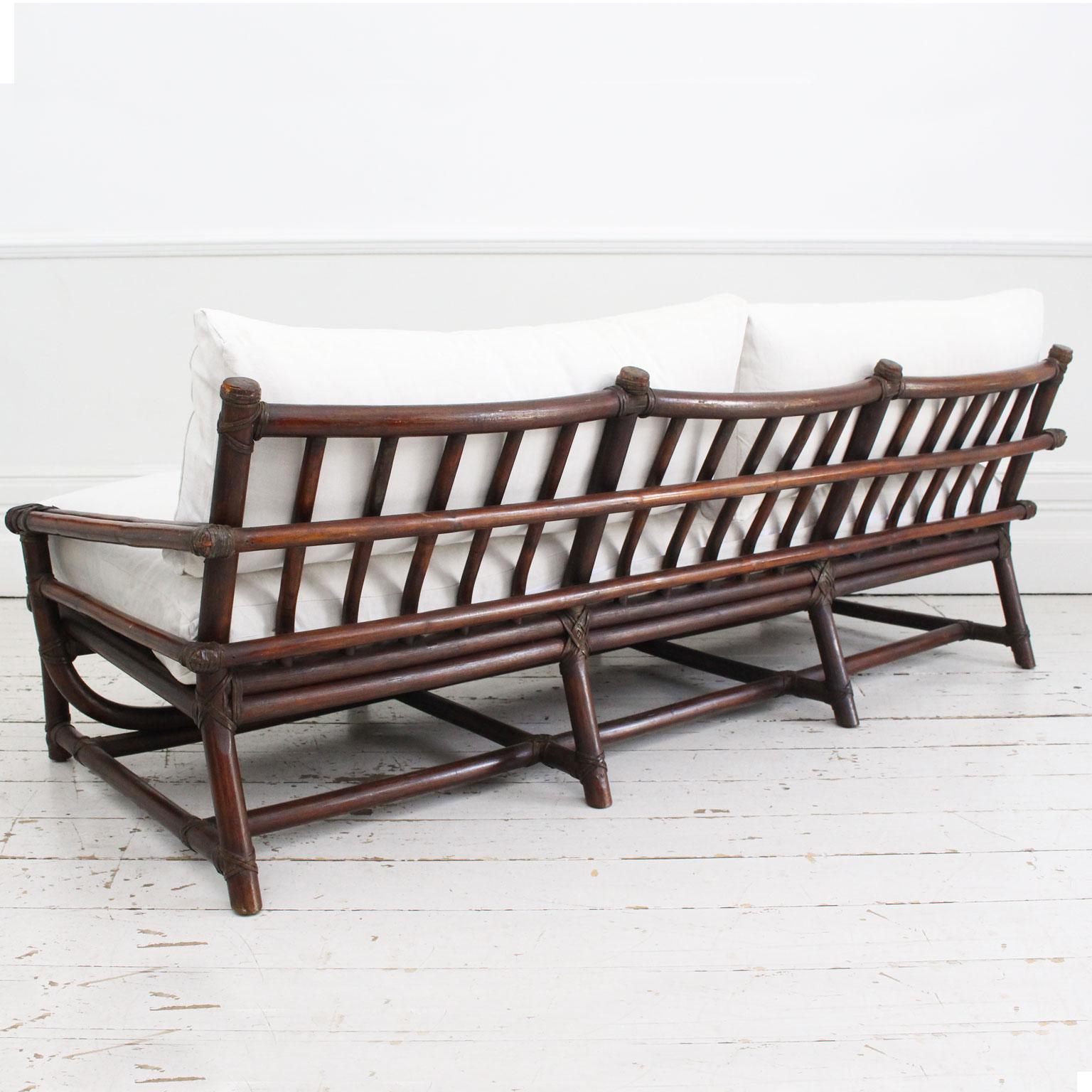 A 1950's French Dark Bamboo Sofa with Antique Linen Cushions 1