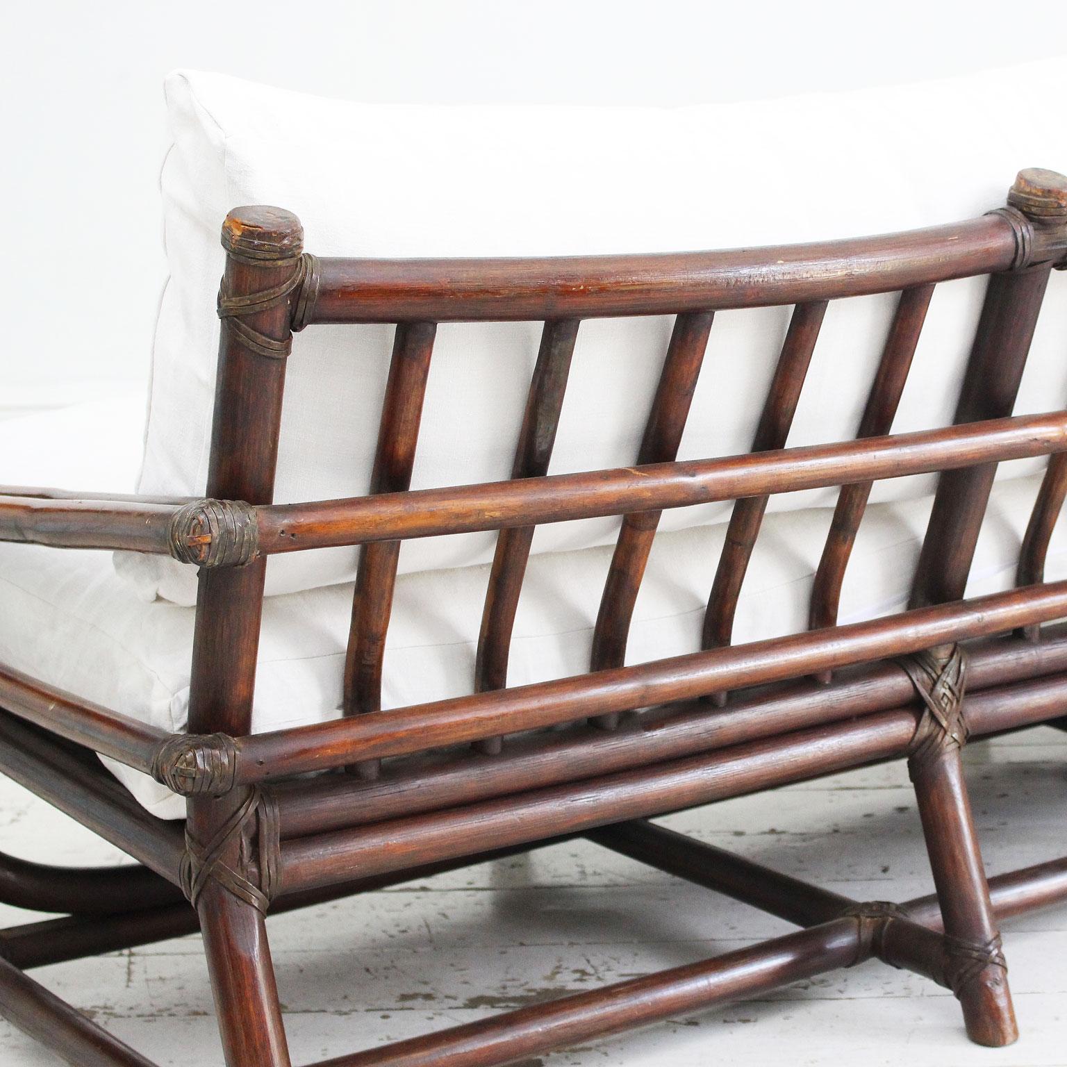 A 1950's French Dark Bamboo Sofa with Antique Linen Cushions 2