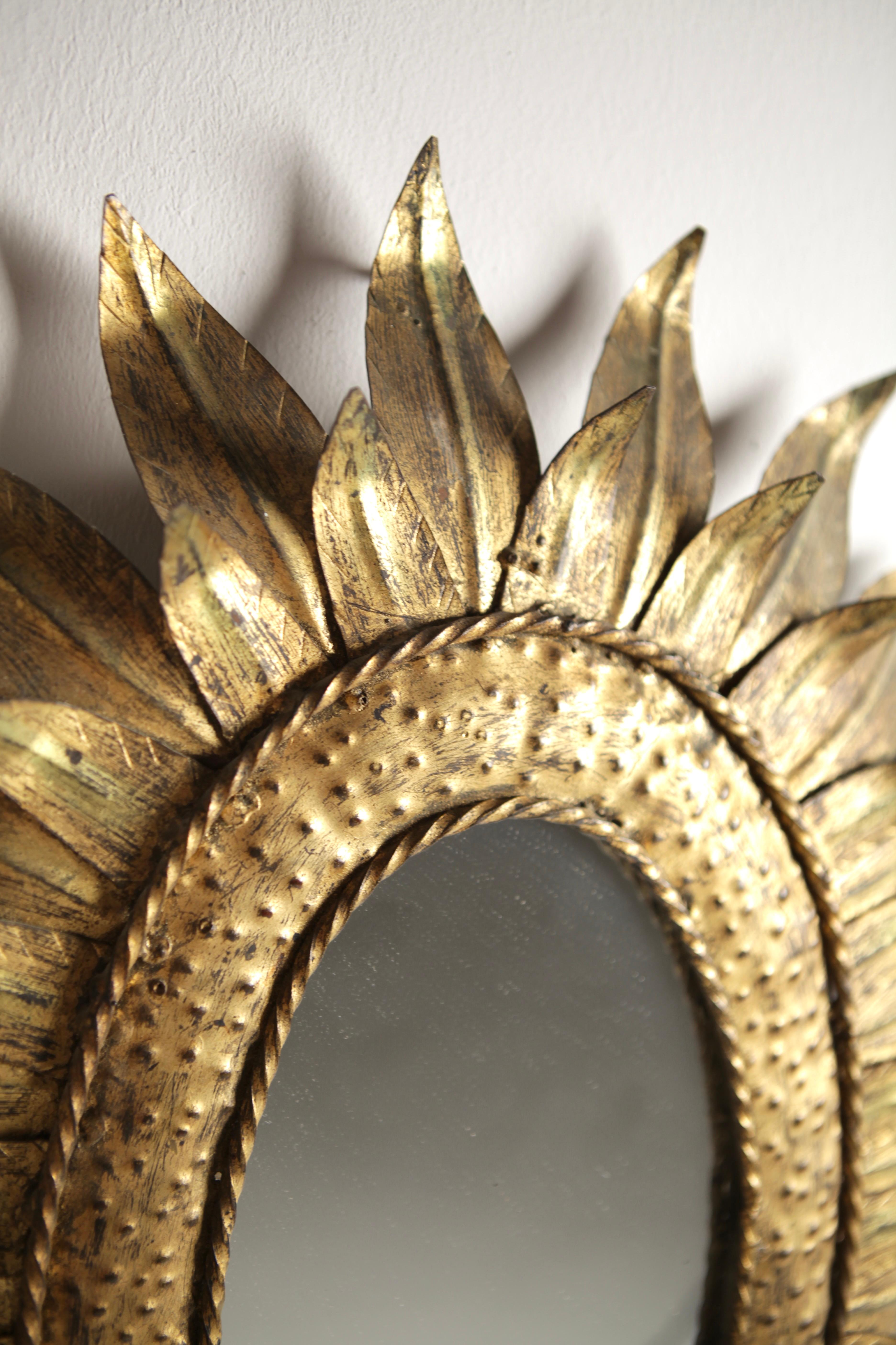 Mid-Century Modern A 1950s Gilded Metal Sunburst Mirror.