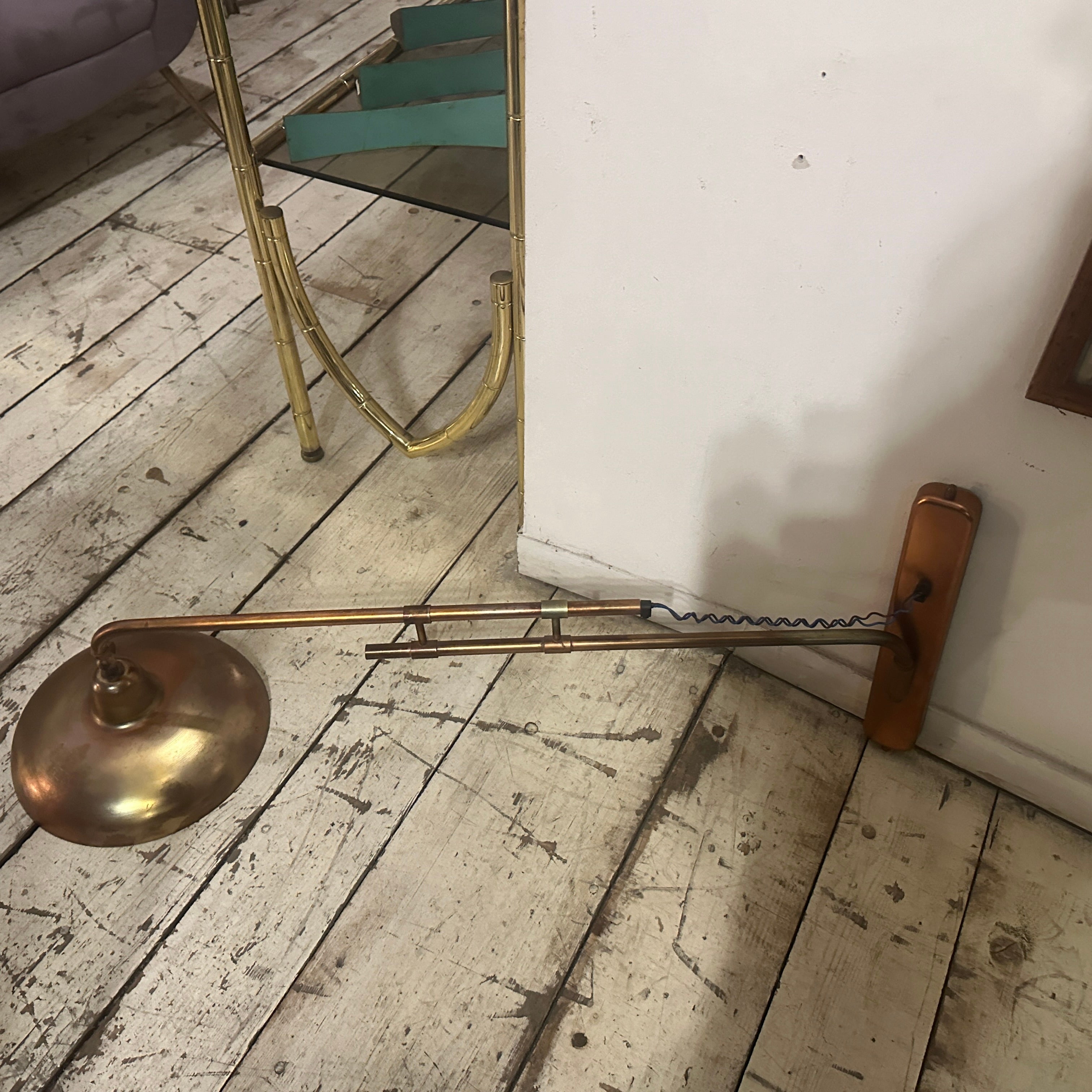An extendable table lamp designed and manufactured in Italy in the Fifties, copper finished iron has signs of use and age, it's in working order. It's a vintage lighting fixture that reflects the design trends of that era with typical
